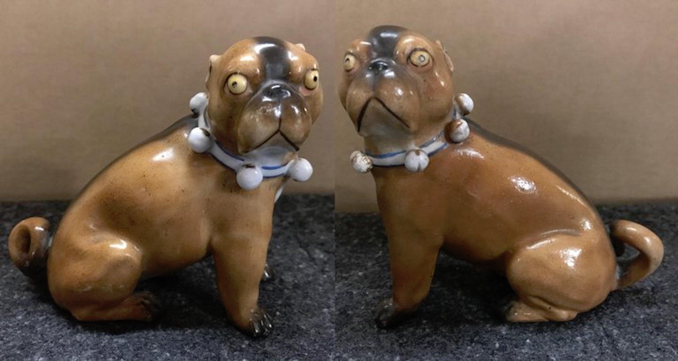 Pair of antique German porcelain pug dogs, each one with realistically modeled with a bell collar
1: 4.25” H x 4.5” W x 3.5” D
2: 4” H x 4.25” W x 2.5” D.
