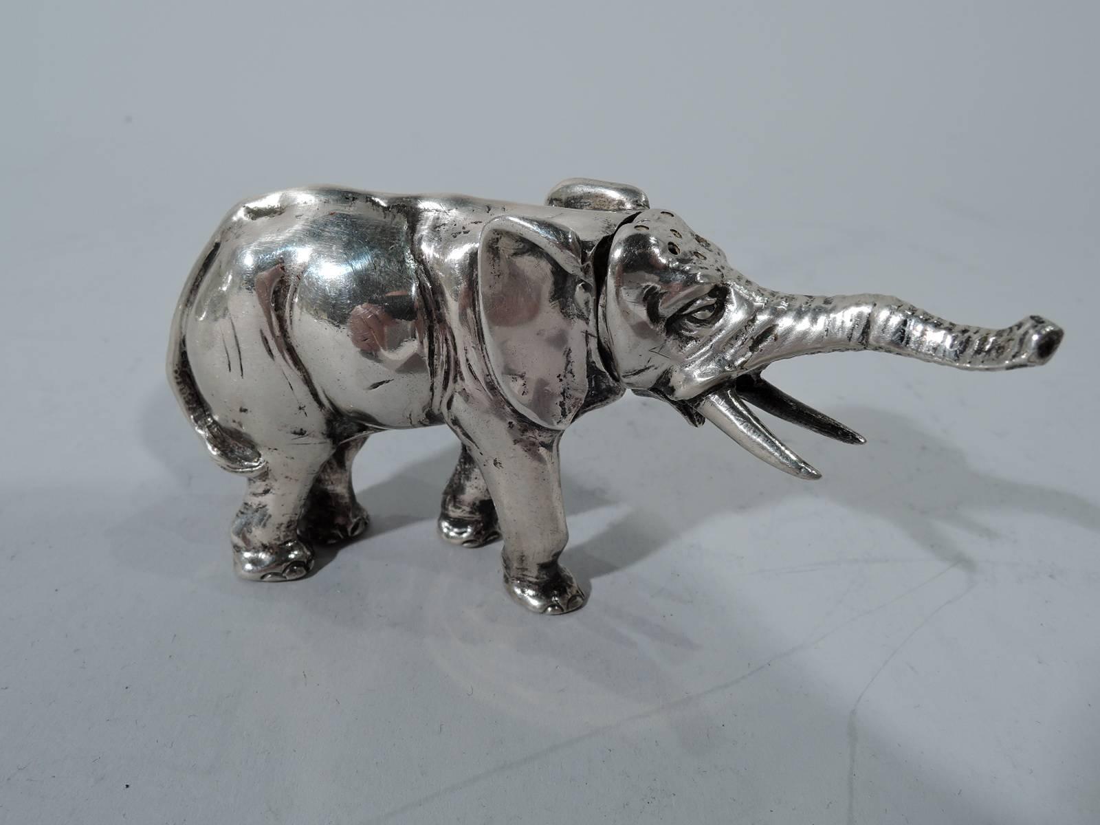Pair of antique German 800 silver figural salt and pepper shakers. Each: An elephant with raised trunk plods along on stumpy legs. Massive and saggy with sharp tusks and flappy ears. Detachable and pierced head. Hallmark includes turn-of-the-century