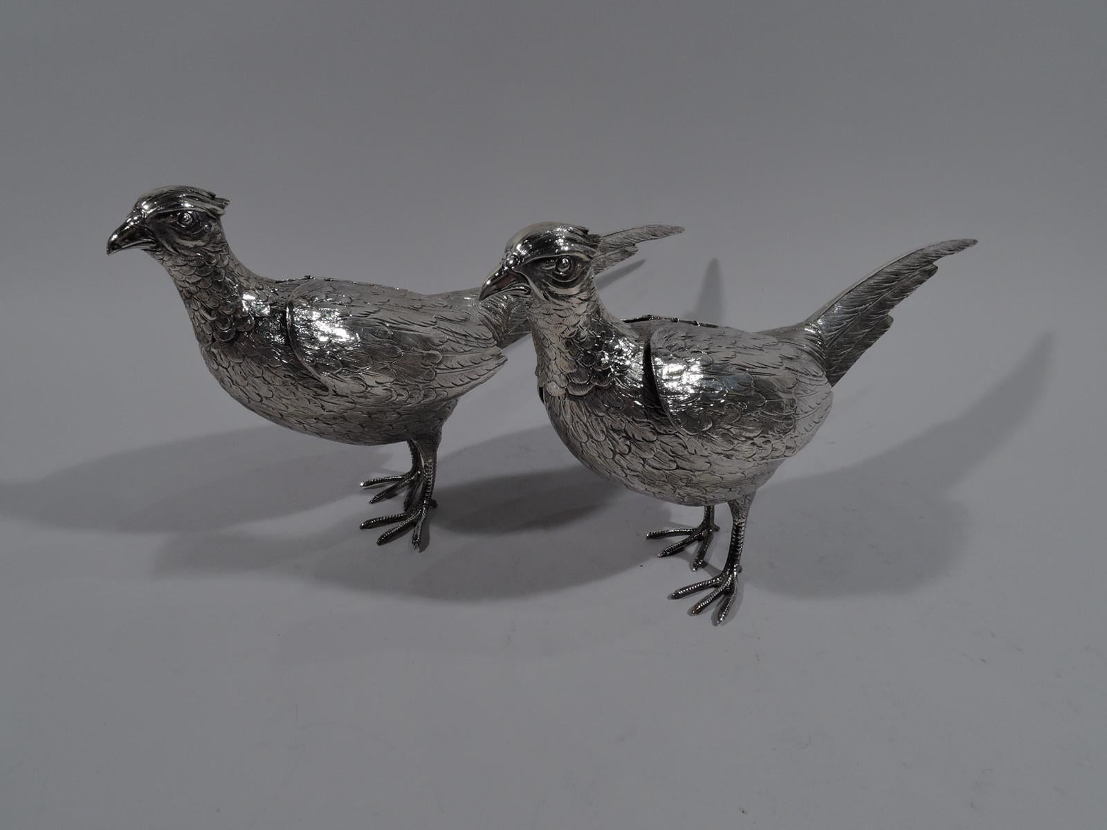 Pair of German 800 silver figural spice boxes, circa 1910. Each: Pheasant with ovoid body and clawed and scaly talons. Head detachable with pierced interior cap. Clawed and scaly talons Welcome dinner party guests, though wings hinged for flight if