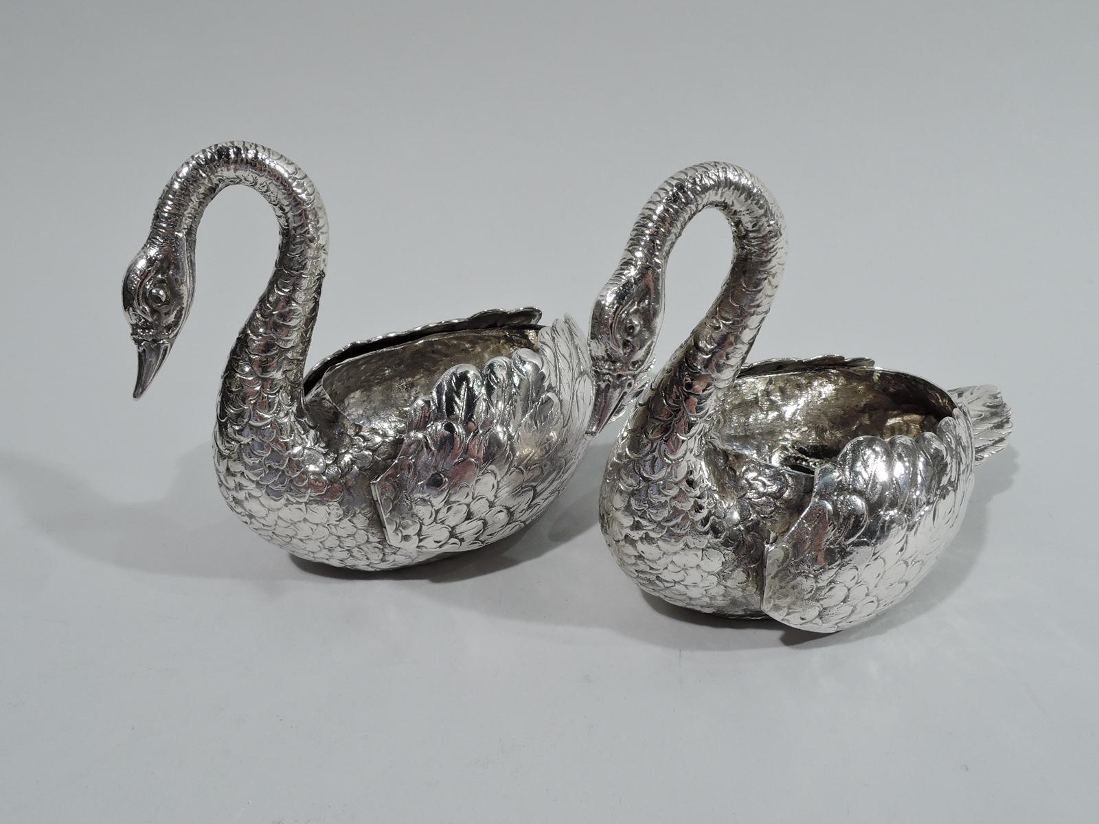 Pair of turn-of-the-century German 800 silver open salts. Each: A swan with hollow oval body and scrolled down-turned neck and head. Erect imbricated tale and plumy hinged wings. Graceful table ornaments for seasoning and treats. Marked.