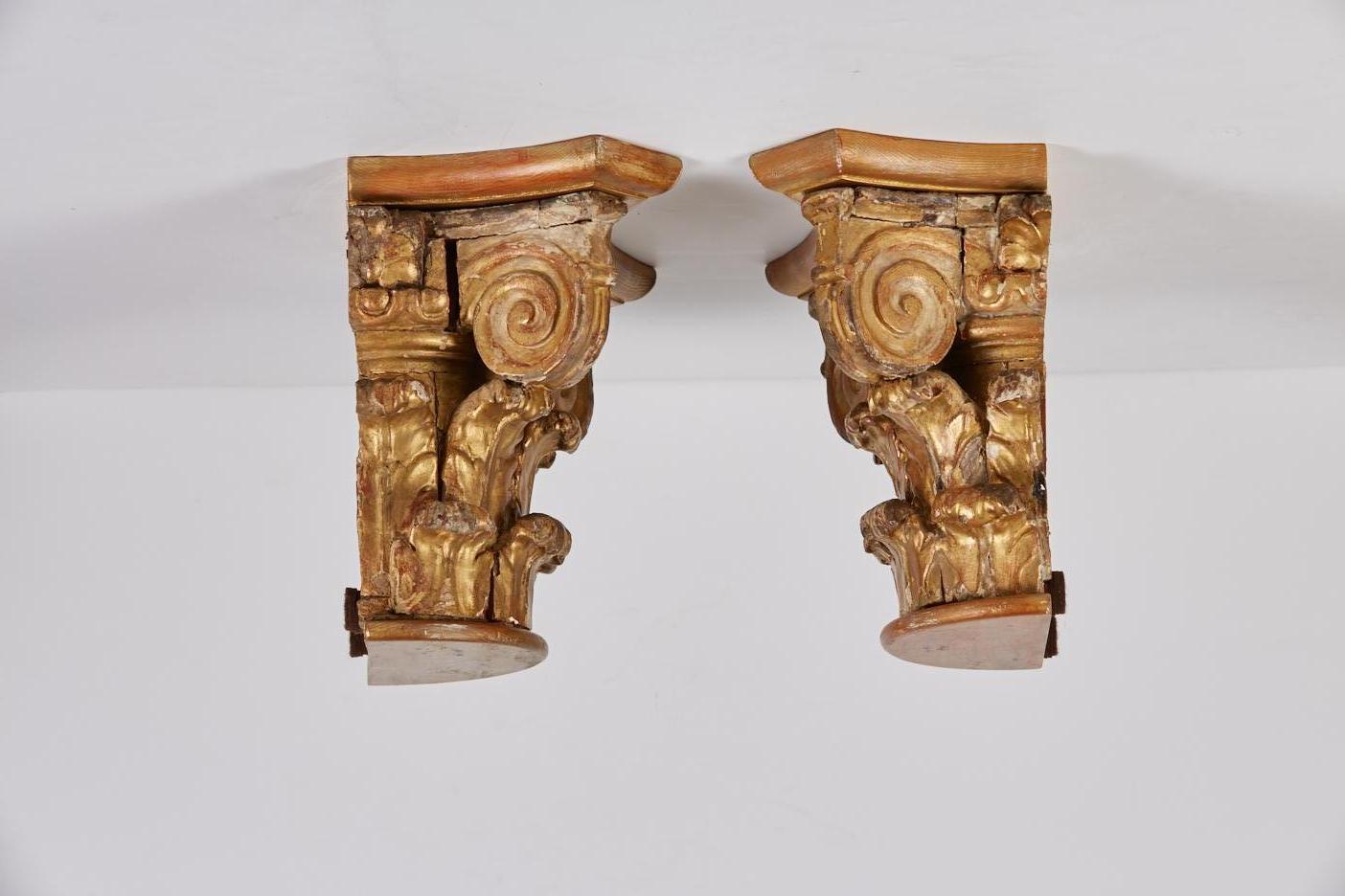 Pair of antique gilt carved wood Corinthian half capitals converted as ornamental bracket shelves with the addition of half round elements at the top and bottom of each.