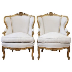 Pair of Antique Giltwood Linen Upholstered Bergère Chairs