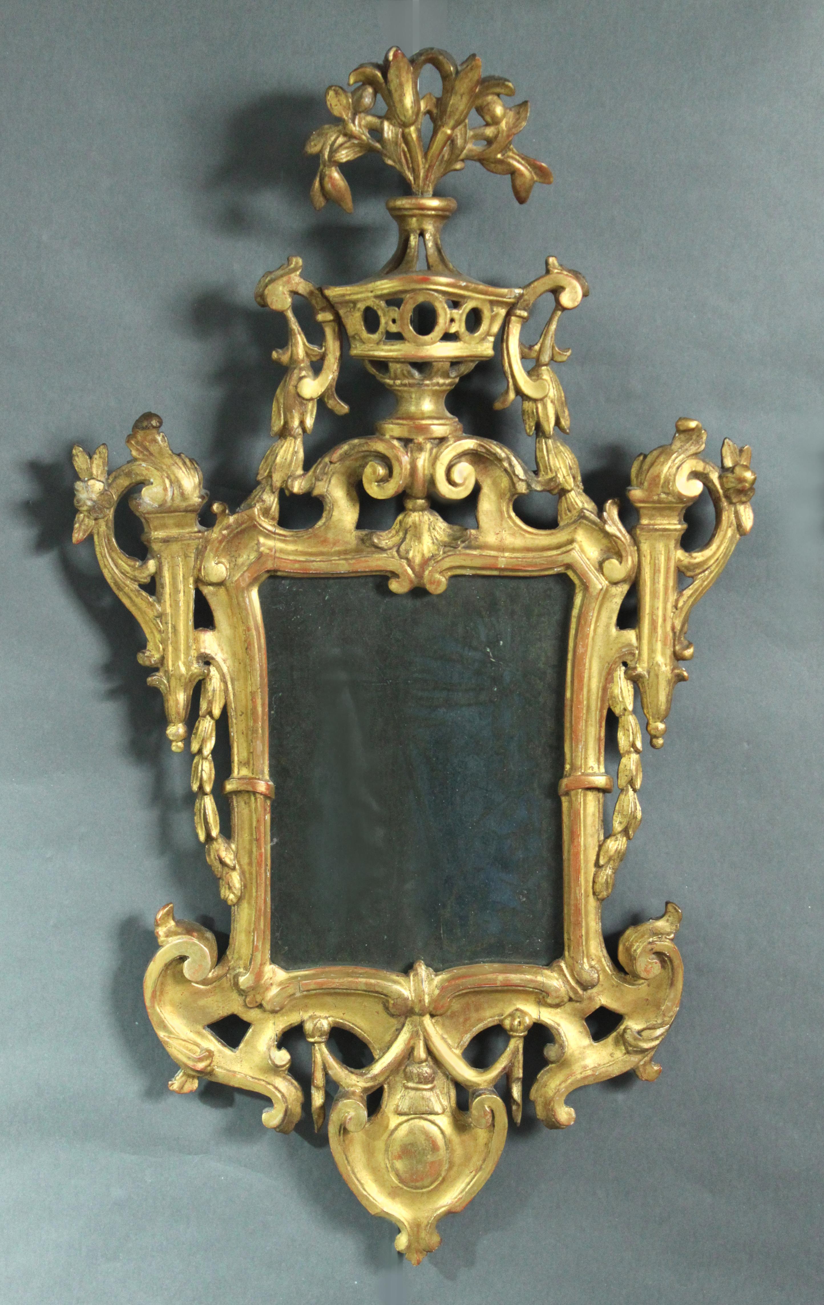 A fine pair late 18th century North Italian carved giltwood girandole mirrors in the neoclassical taste still retaining their original mercury plates.

A similar pair are illustrated in World Mirrors 1650-1900 by Graham Child image