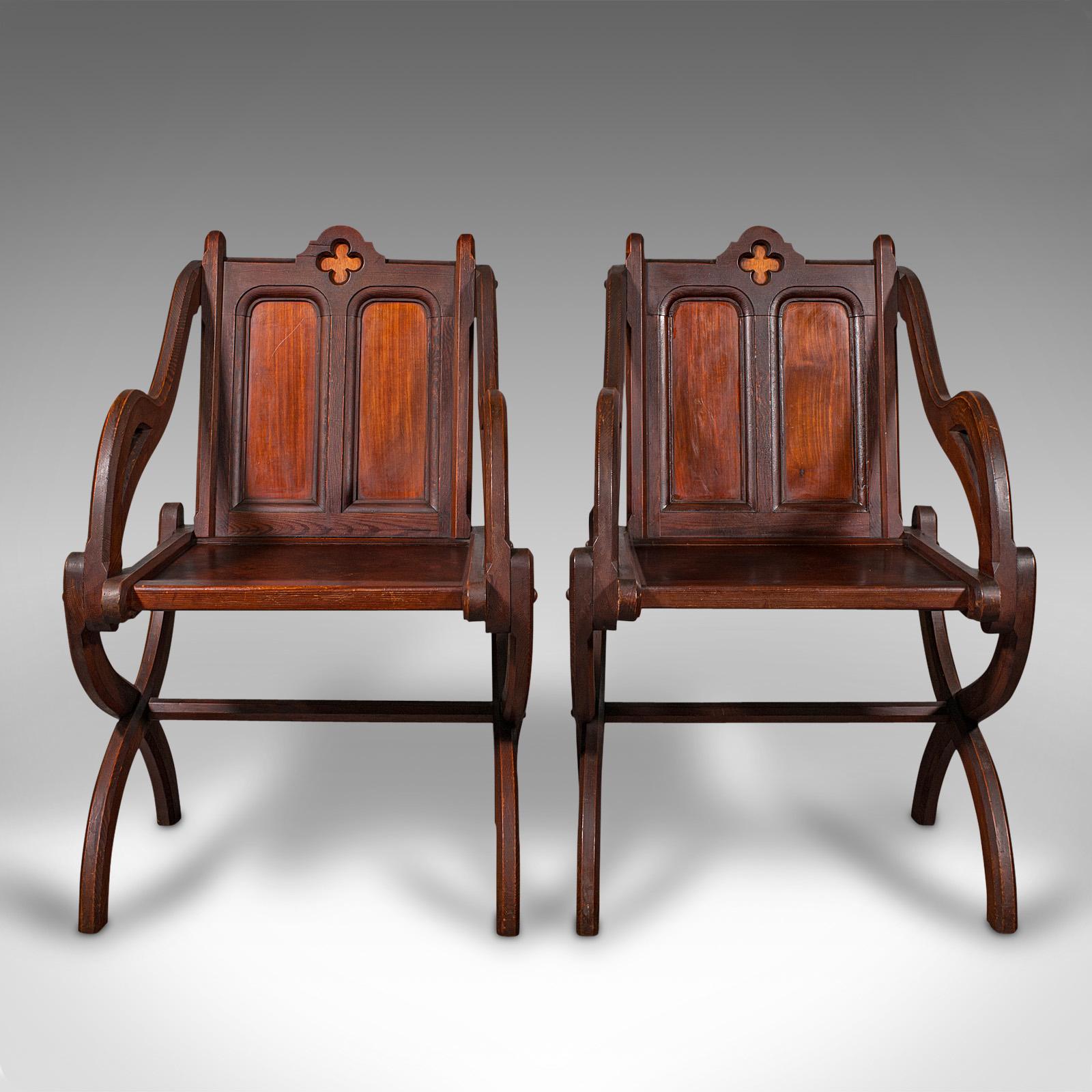 This is a pair of antique Glastonbury chairs. An English, pitch pine decorative armchair with Gothic overtones, dating to the late Victorian period, circa 1900.

Two delightful Glastonbury chairs, offering superb form and detail
Displaying a