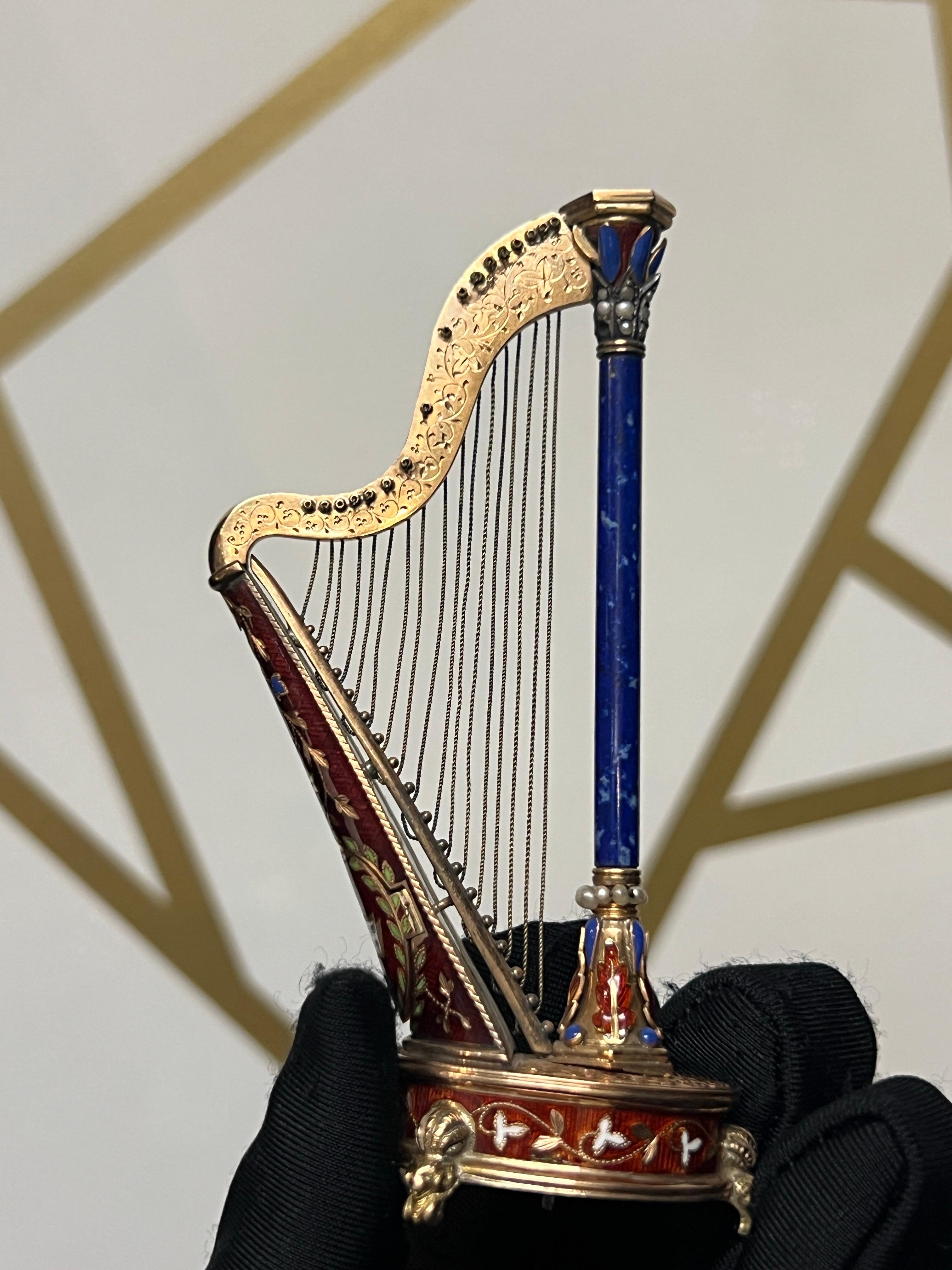 Pair of Antique Gold and Enamel Musical Harps

These rare harps showcase exquisite hand-painted enamel. 

Their bodies are adorned with red enamel, with a lapis lazuli column accented with pearls at the base.

Approximate Height: 3.5