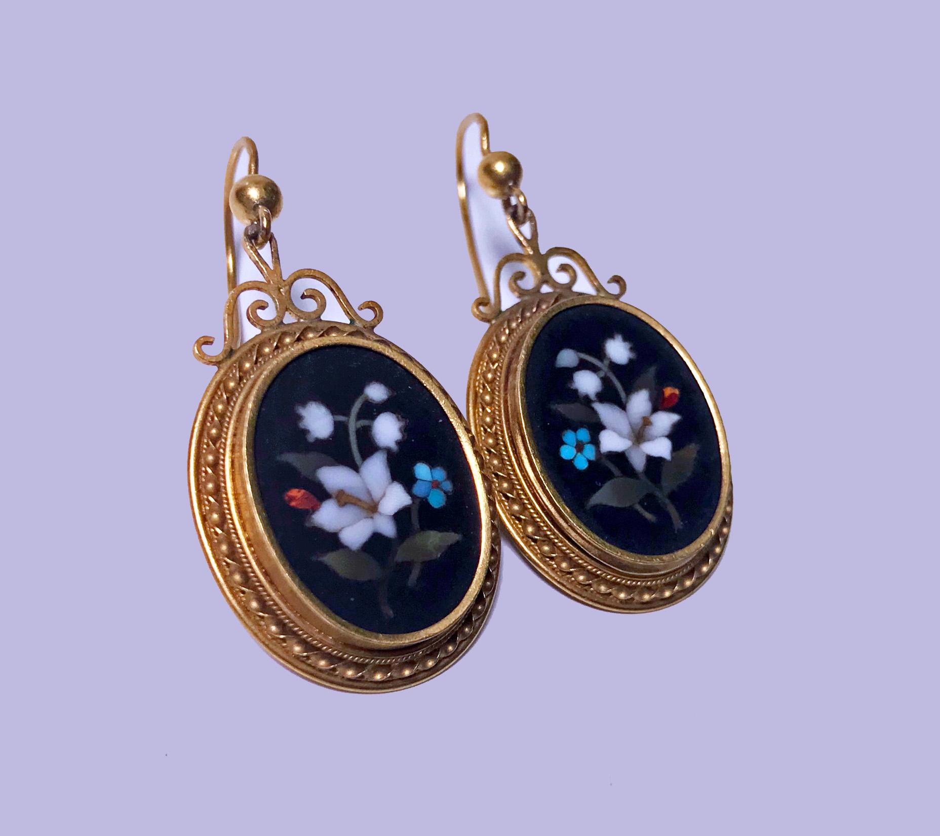 Pair of Antique 18K Pietra Dura Earrings, C.1875. Each of oval drop form, fine pietra dura floral white, blue, red, lilac inlay colours, the surround gold mount etruscan rope design, shepherd hook fitments, stamped with continental marks. Gold acid