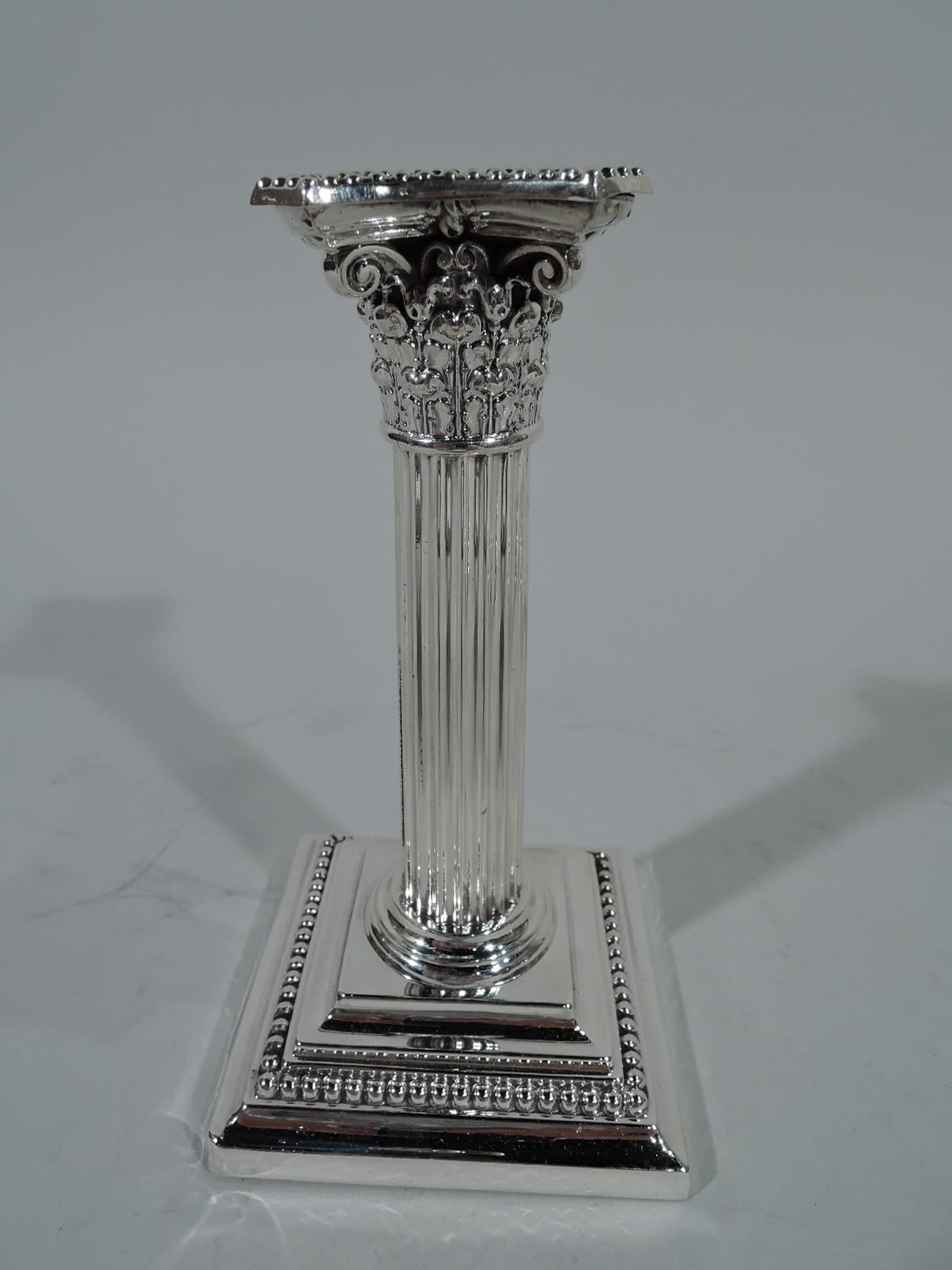 Pair of Edwardian sterling silver candlesticks. Made by Gorham in Providence. Each: Classical fluted column with composite capital and stepped square foot. Beading on detachable bobeche and foot. Hallmark includes A3204 and date symbols for 1904 and
