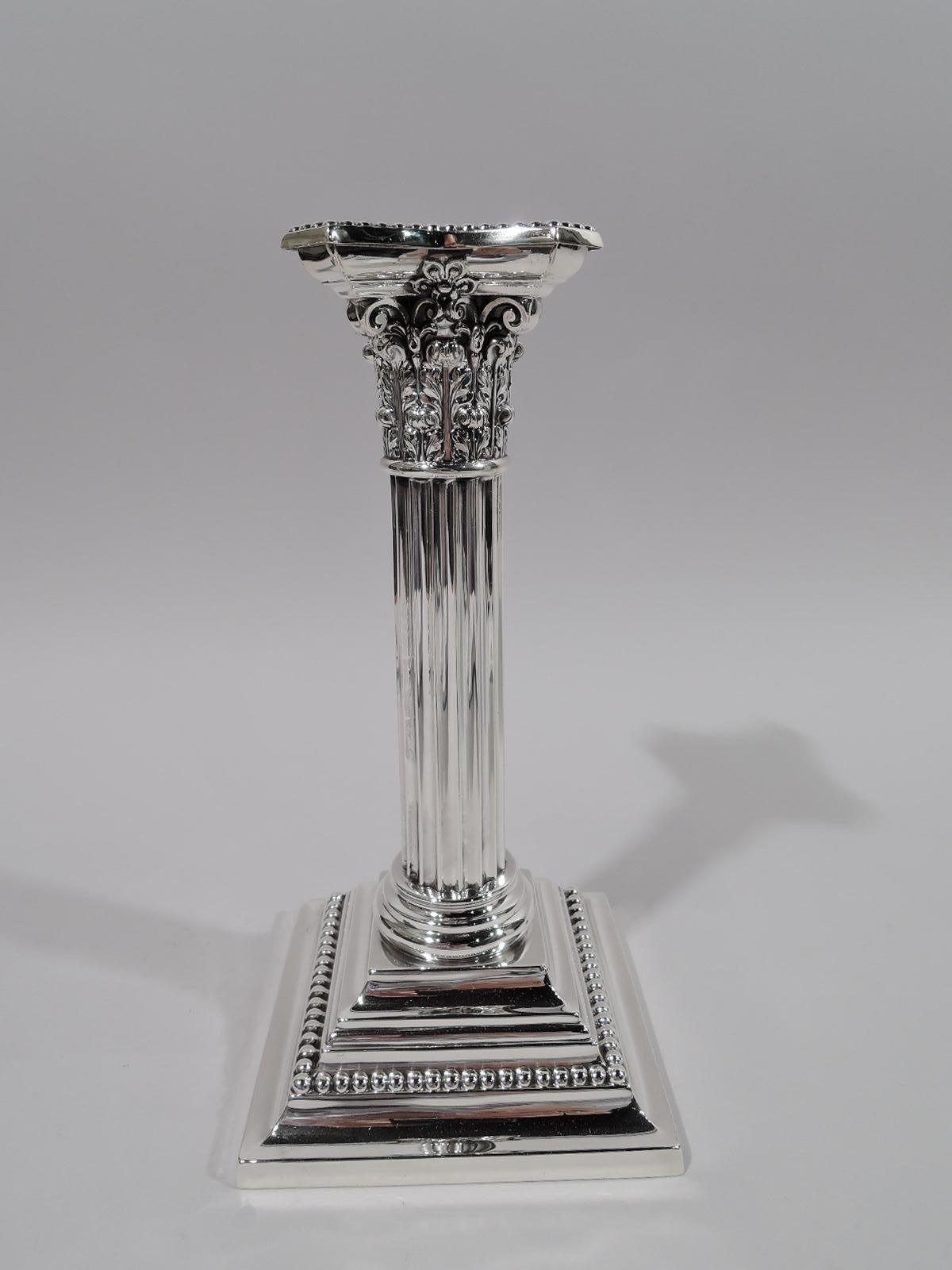 Pair of sterling silver classical column candlesticks. Made by Gorham in Providence in 1906. Each: Fluted shaft on stepped square base. Corinthian capital with chamfered, concave, and detachable bobeche. Beading. Fully marked including maker’s and