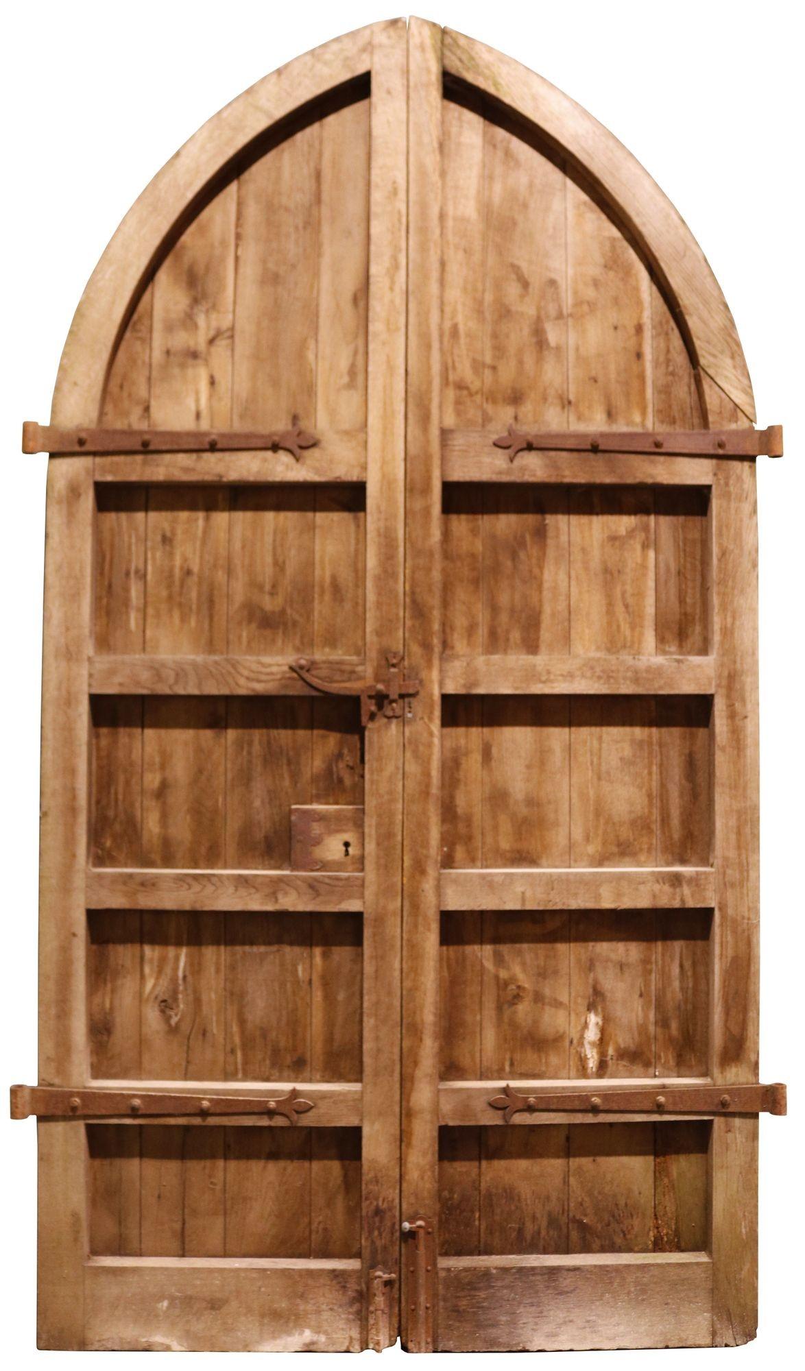 Pair of Antique Gothic Style Church doors. A set of large arched antique doors with original hardware and a weathered time worn appearance. These wonderful oak doors feature fantastic blacksmith made wrought iron hinges and door bolts.