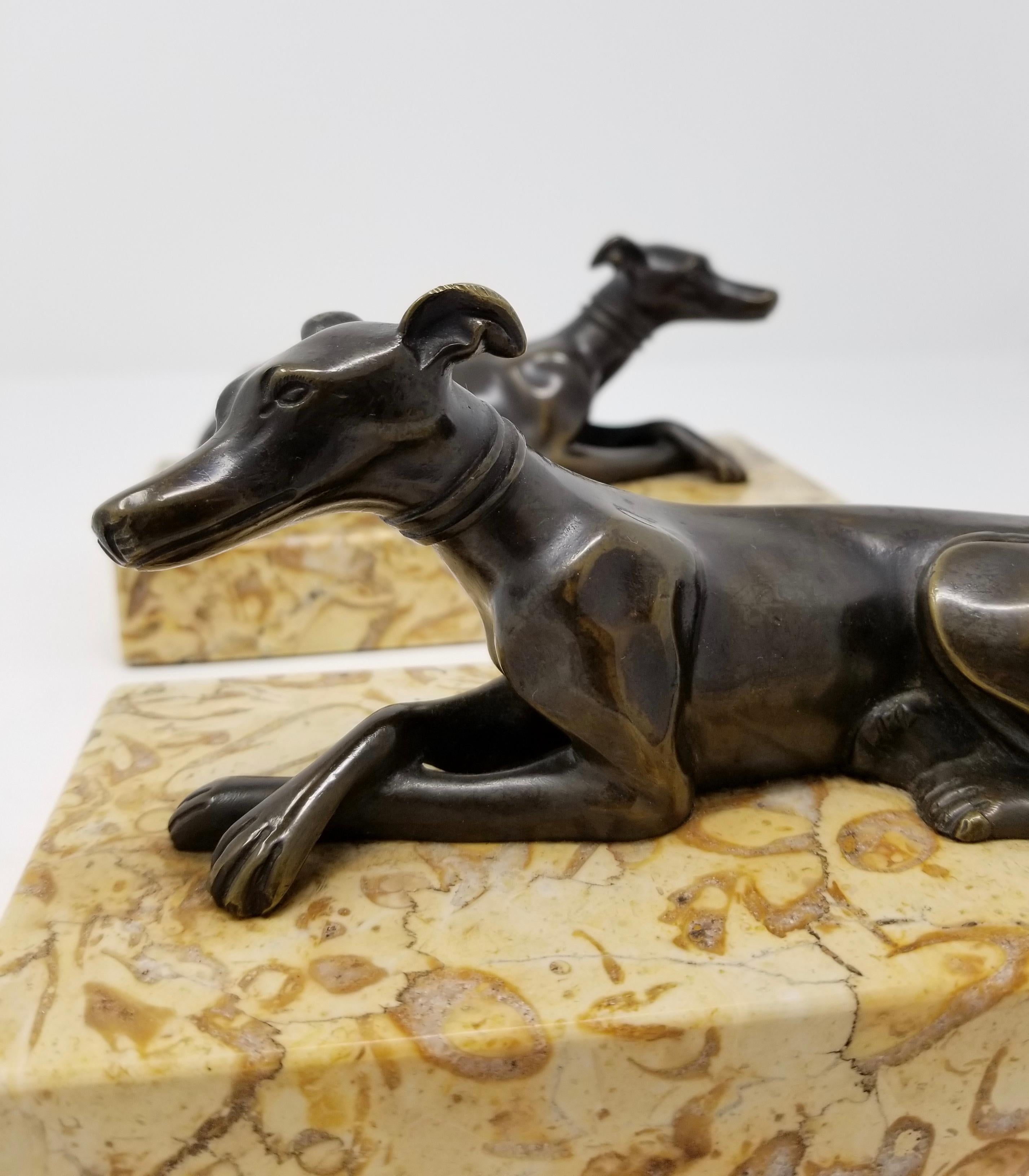 Pair of Antique Grand Tour Patinated Bronze Grey Hounds Seated Marble Plinths In Good Condition For Sale In New York, NY