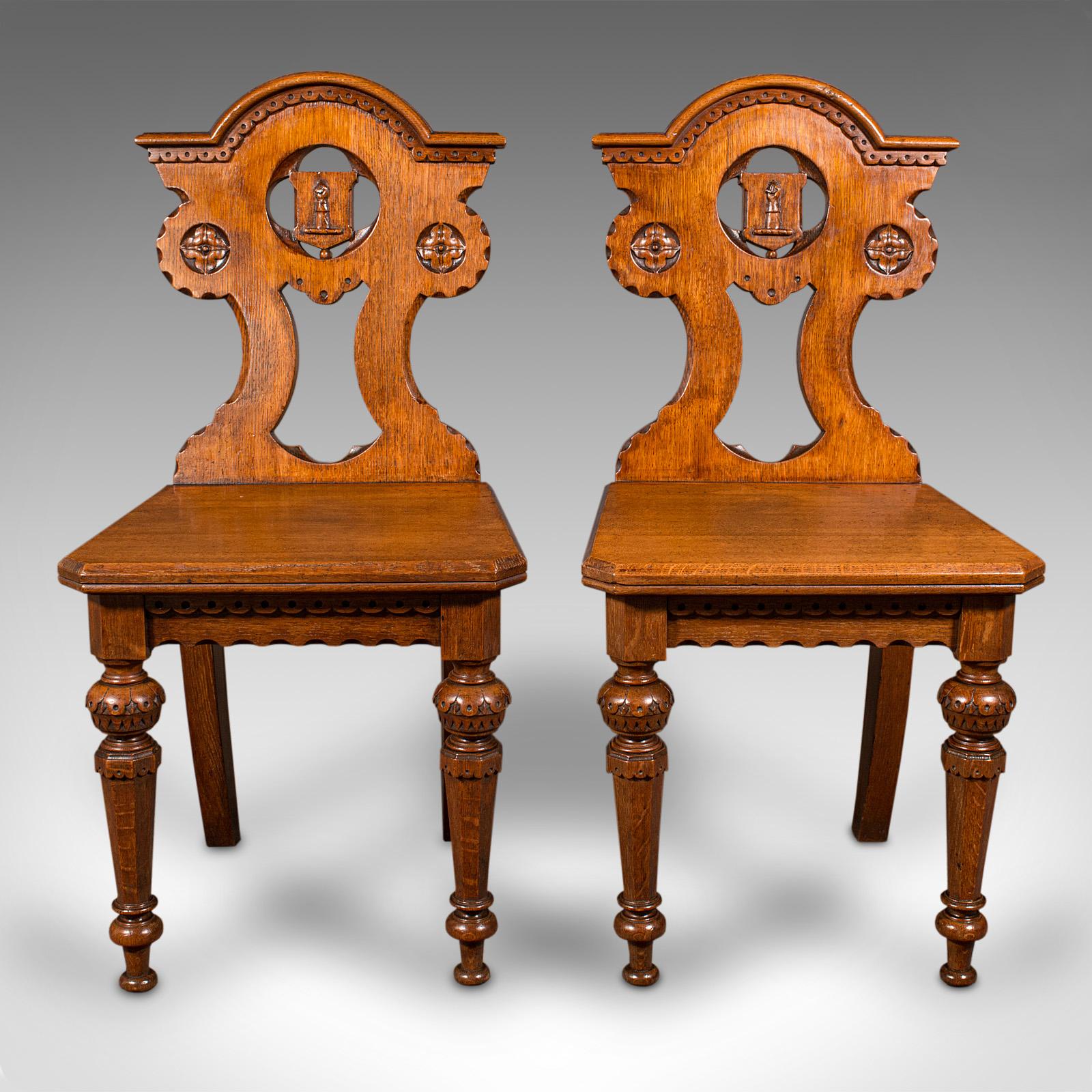 This is a pair of antique hall chairs. A Scottish, oak seat in Arts & Crafts taste, dating to the late Victorian period, circa 1890.

Striking and exceptional, a treat for the grandest of reception halls
Displaying a desirable aged patina and in
