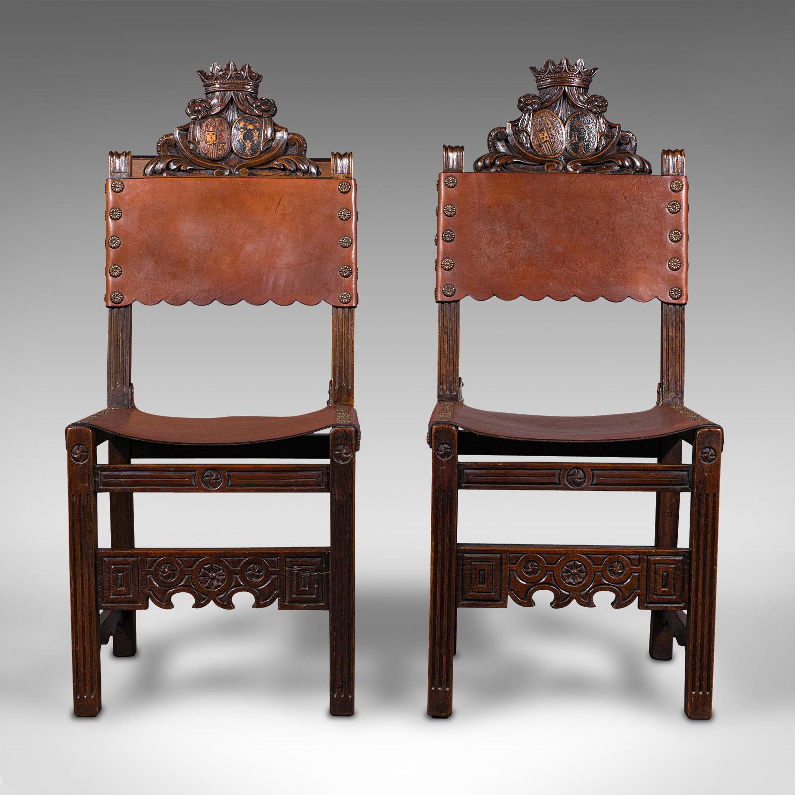 This is a pair of antique hall seats. A Scottish, dark stained pine side chair in Jacobean revival taste, dating to the Edwardian period, circa 1910.

Strong heraldic overtones with appealing colour
Displaying a desirable aged patina and in good