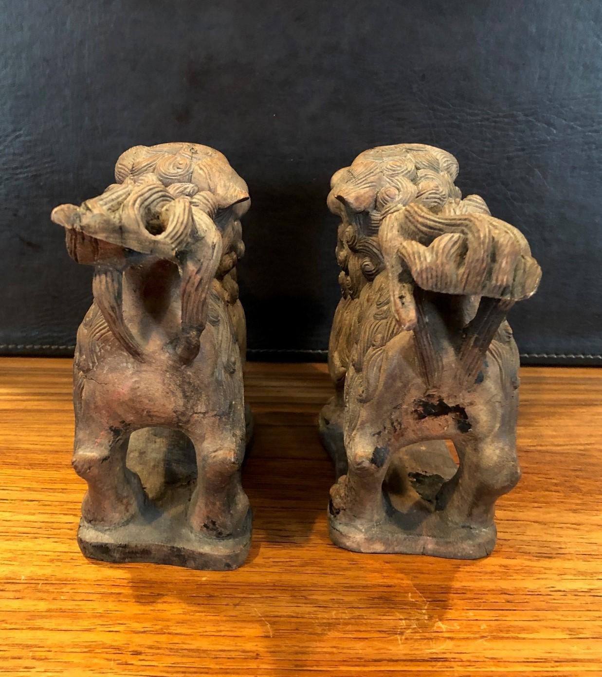 20th Century Pair of Antique Hand Carved Hard Wood Chinese Foo Dogs For Sale