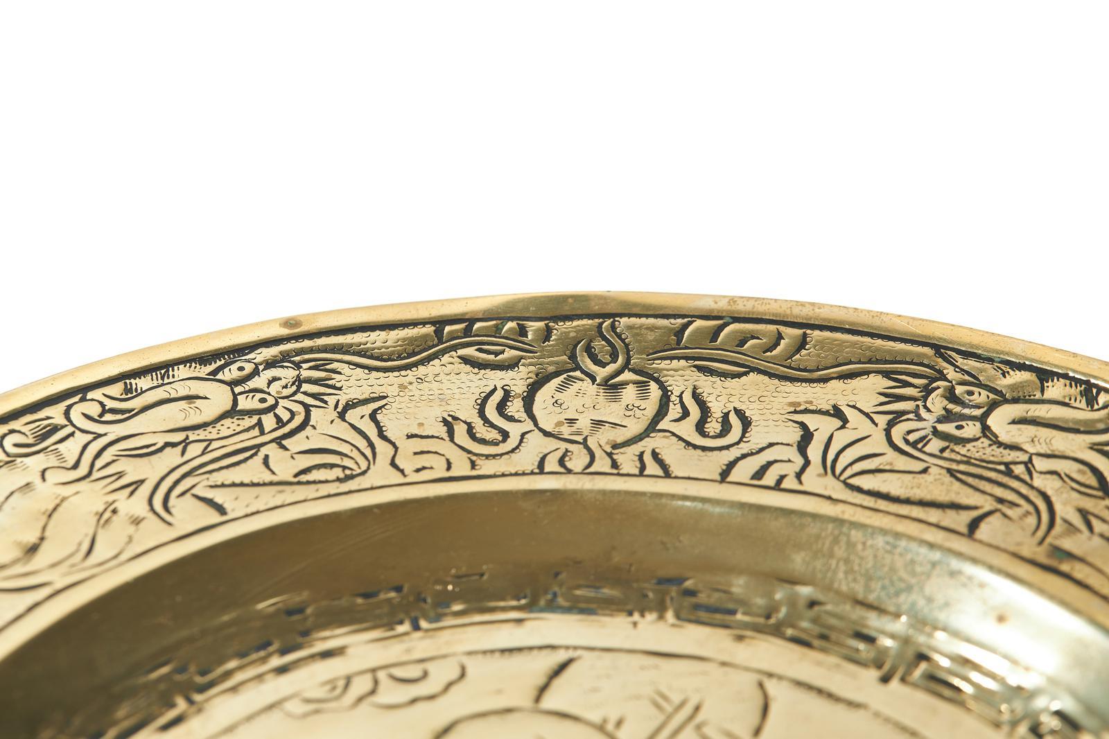 Pair Of Antique Brass/Bronze Chinese Plates with hand engraved detail. The plates decorated all over with central design of 2 figures. Lovely overall condition that is consistent with age.