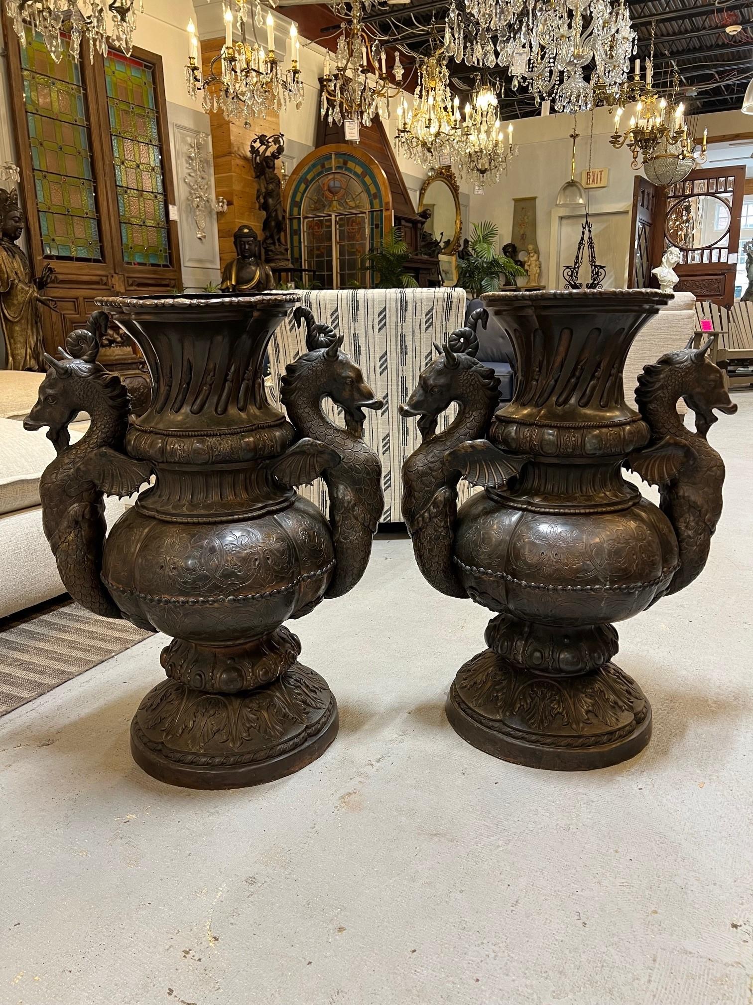 A rare pair of 19th century handcrafted copper urns with mythological seahorses and beautiful scroll work. They do have an iron brace or bracket on the inside to support the copper, shown in the photos. The opening is 13
