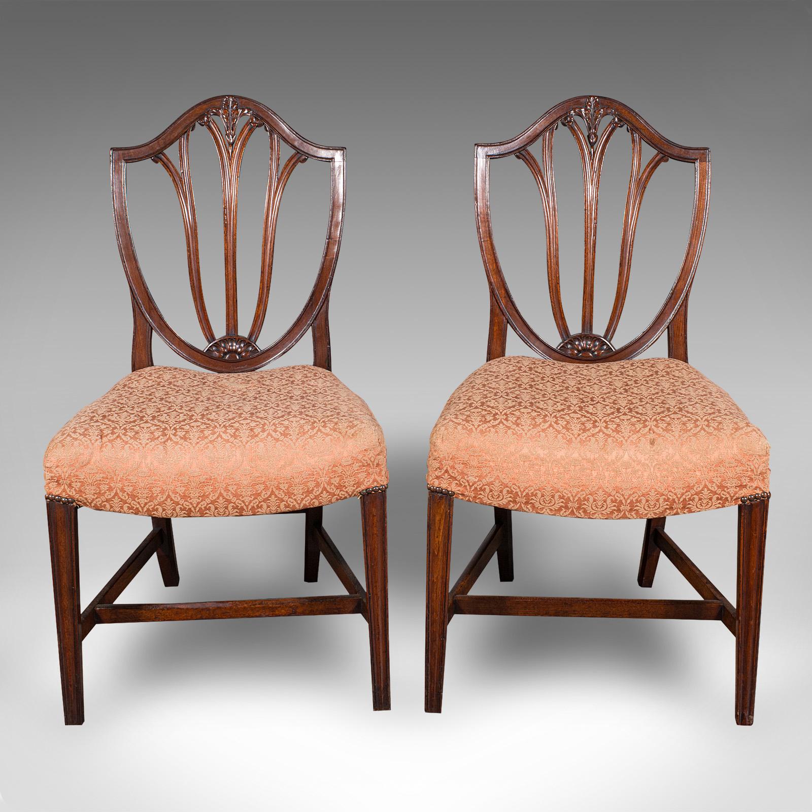 This is a pair of antique Hepplewhite taste side chairs. An English, fruitwood decorative hall seats, dating to the Georgian period, circa 1790.

Superb country house appeal with the distinction of the Hepplewhite influence
Displaying a desirable
