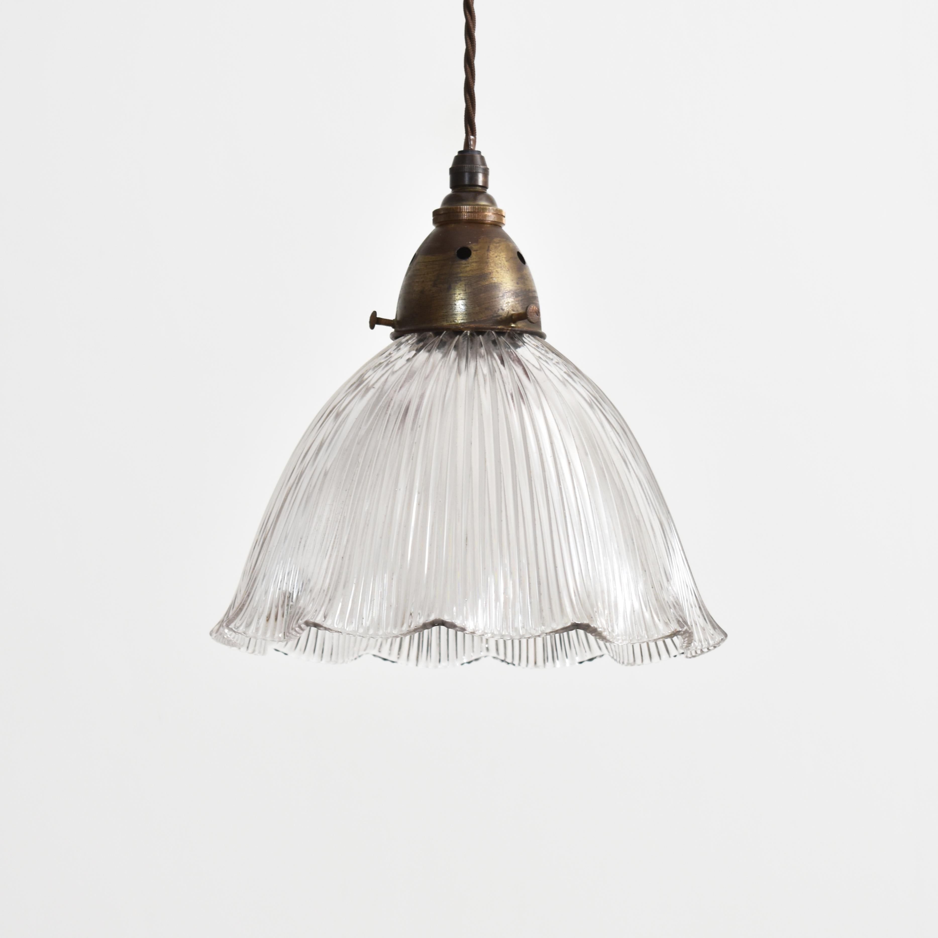 Pair Of Antique Glass Holophane Pendant Lights – C

A pair of antique pendant glass lights Manufactured by ‘Holophane’. The shapely glass prismatic shades look great both lit and unlit. The lights have retained their original brass galleries. The