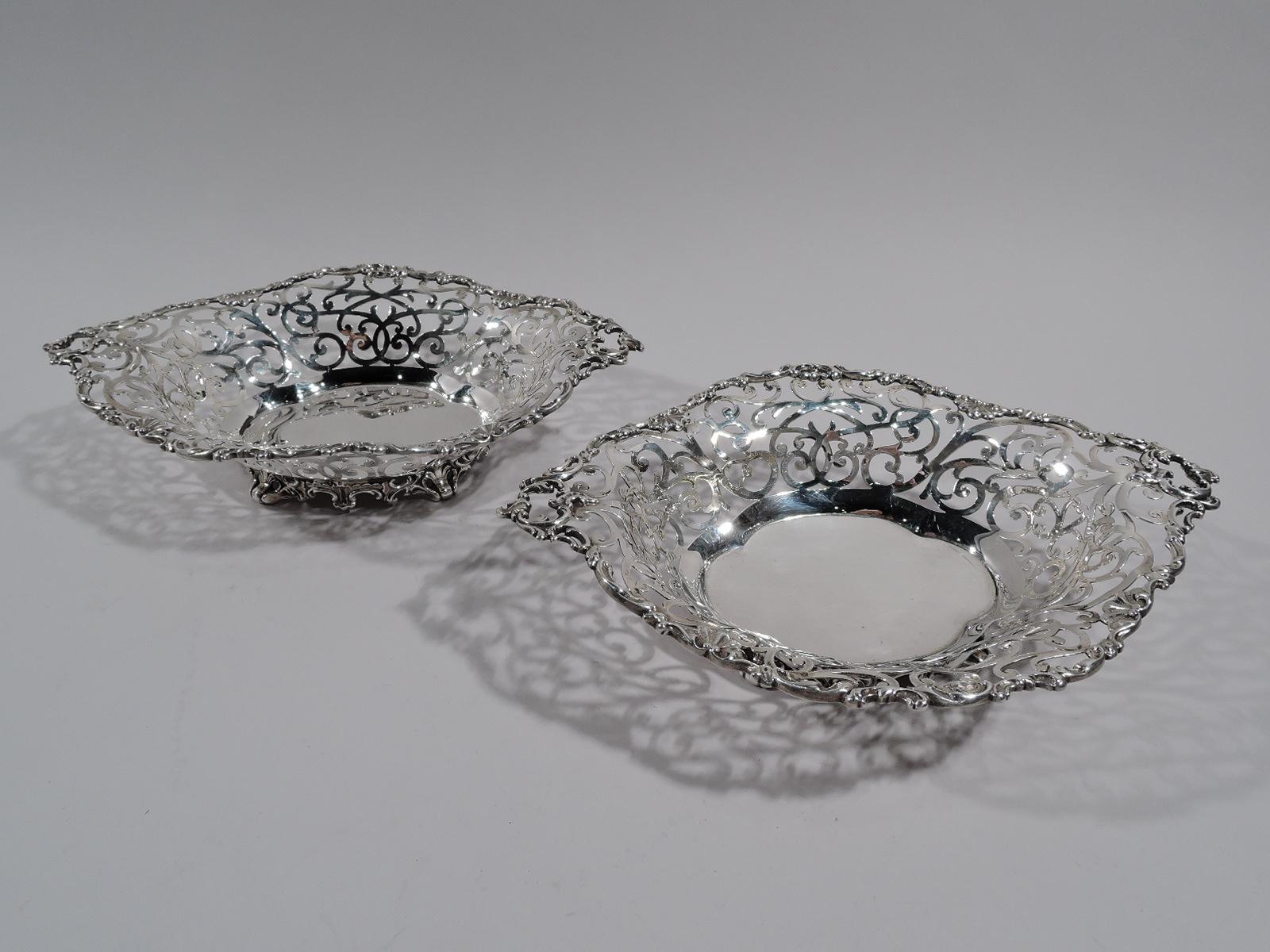 Pair of Edwardian sterling silver bowls. Made by Howard in New York in 1895. Each: Solid quatrefoil well sides have open scrolls and tendrils. Rim has applied scrolls and open end-handles. Scrolled foot ring. Fully marked including maker’s stamp and