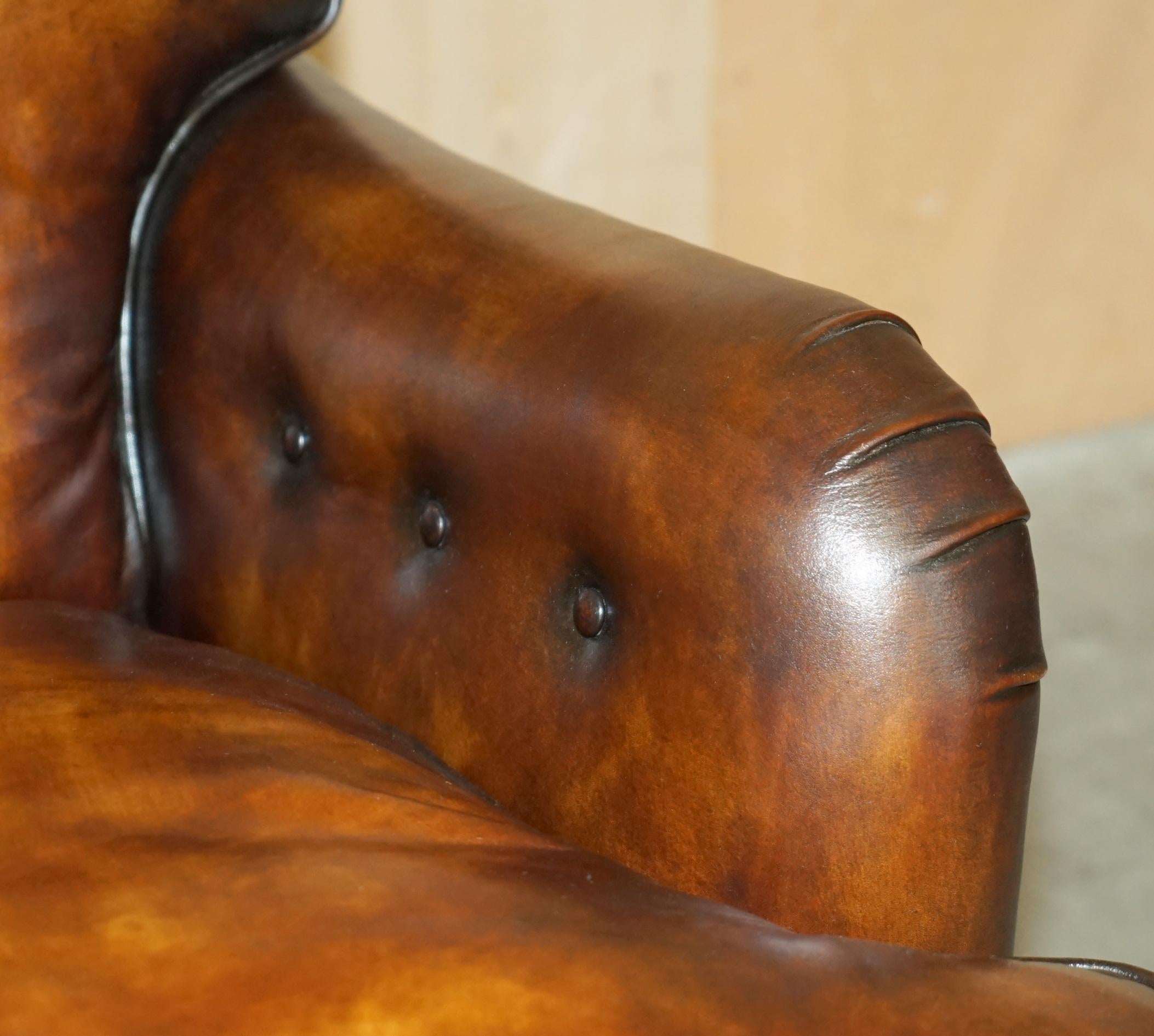 Hand-Crafted PAIR OF ANTIQUE HOWARD & SON's BRIDGEWATER BROWN LEATHER ARMCHAiRS & FOOTSTOOL For Sale