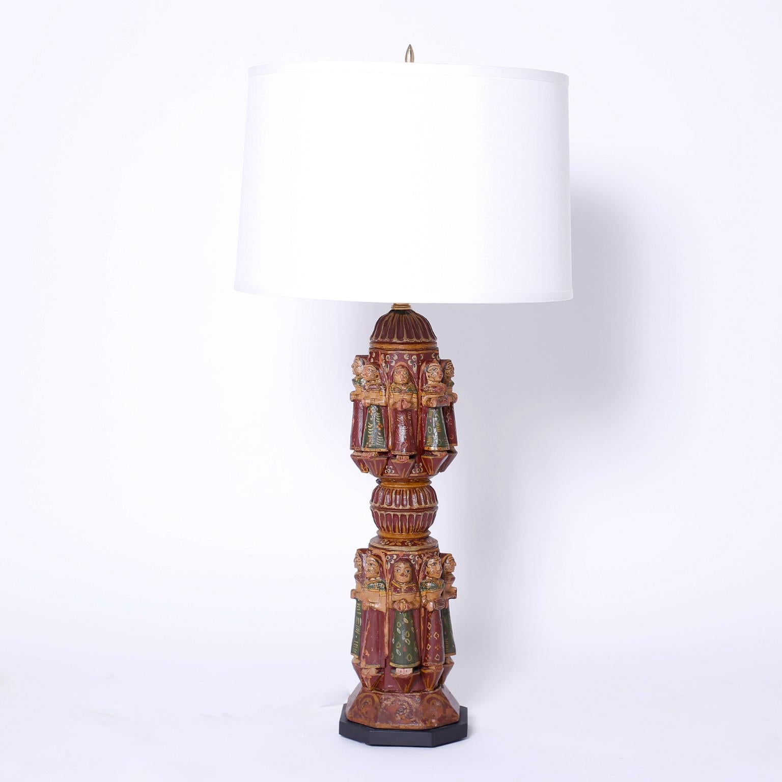 Pair of antique bed posts now table lamps carved and polychromed wood with two tiers of maidens in festive garb.