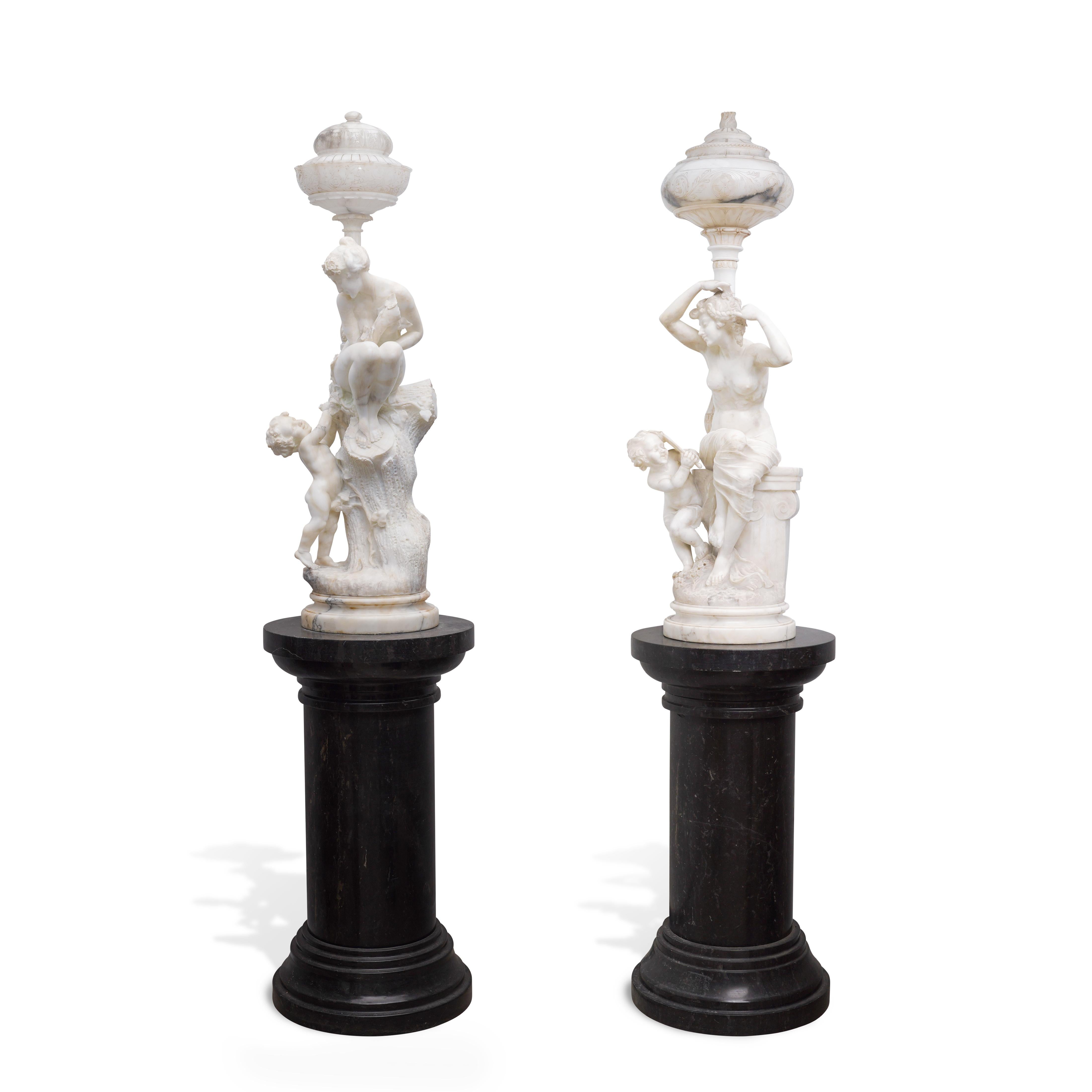 A beautiful pair of antique Italian hand carved alabaster lamps / torcheres depicting Venus and a cupid. One is a classic allegory to Titian's painting 