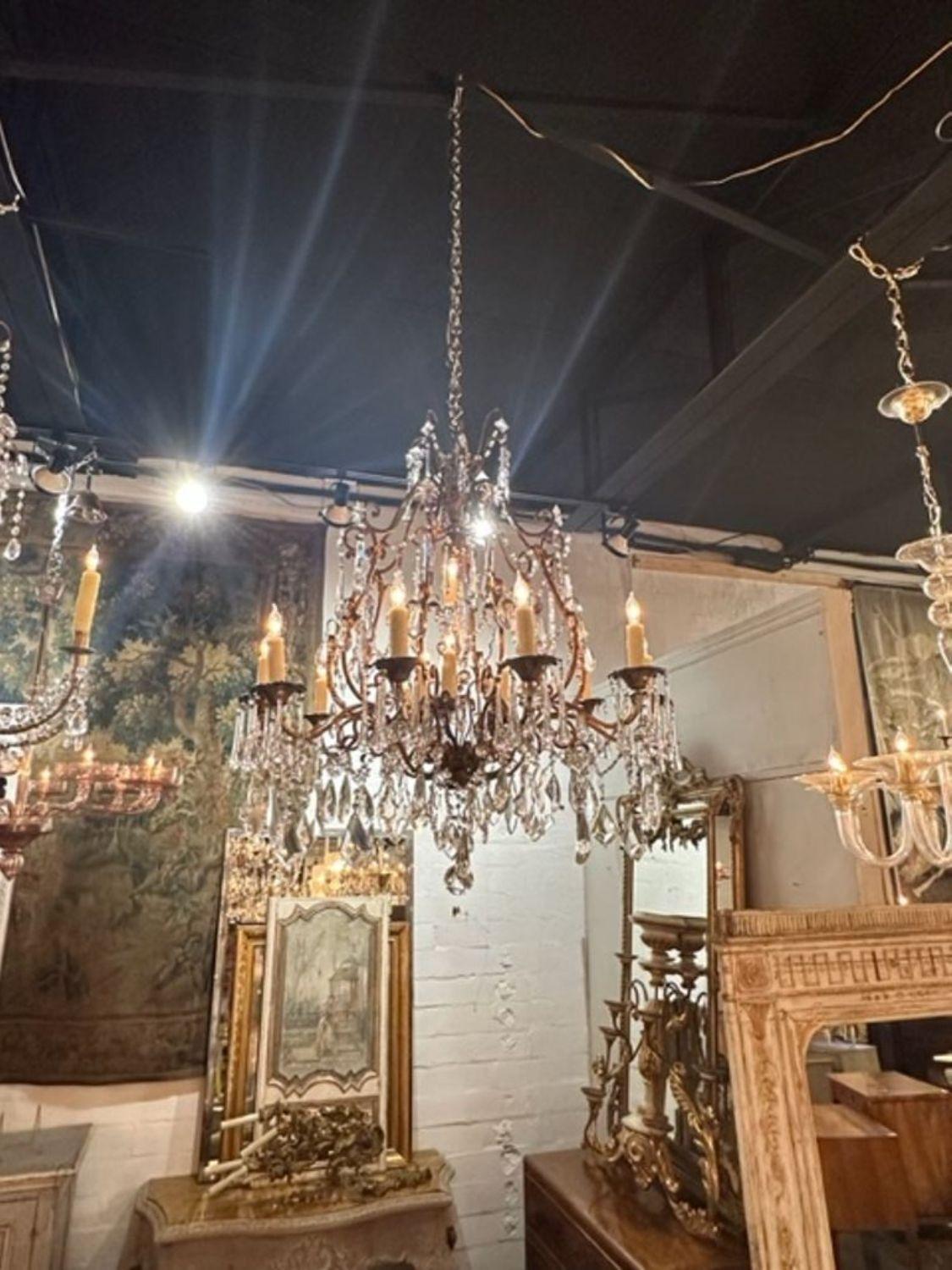 Wonderful pair of antique Italian crystal and amethyst chandeliers with 14 lights. Covered in gorgeous crystals on a beautiful curved base. A lovely pair!