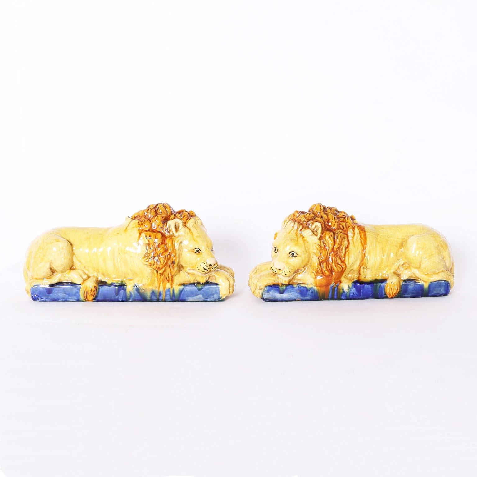 Antique Italian true pair of lions crafted in terra cotta, decorated, glazed and forever in repose.