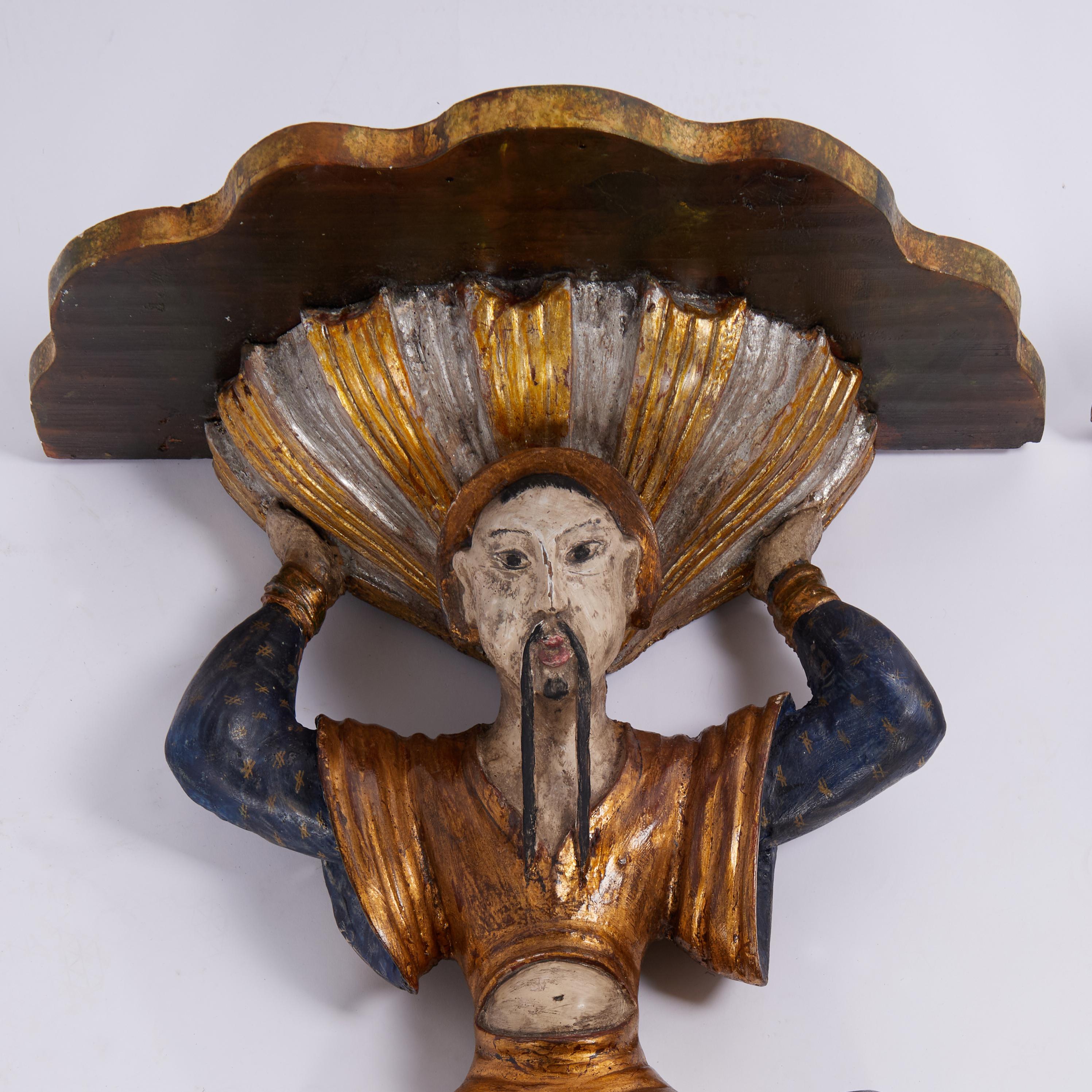 Rare and remarkable pair of 18th century Italian wall brackets hand carved in walnut in the dramatic likeness of Asian figures with Fu Manchu style mustaches and polychrome and gilt finishes now aged to perfection. Best of the genre. 
