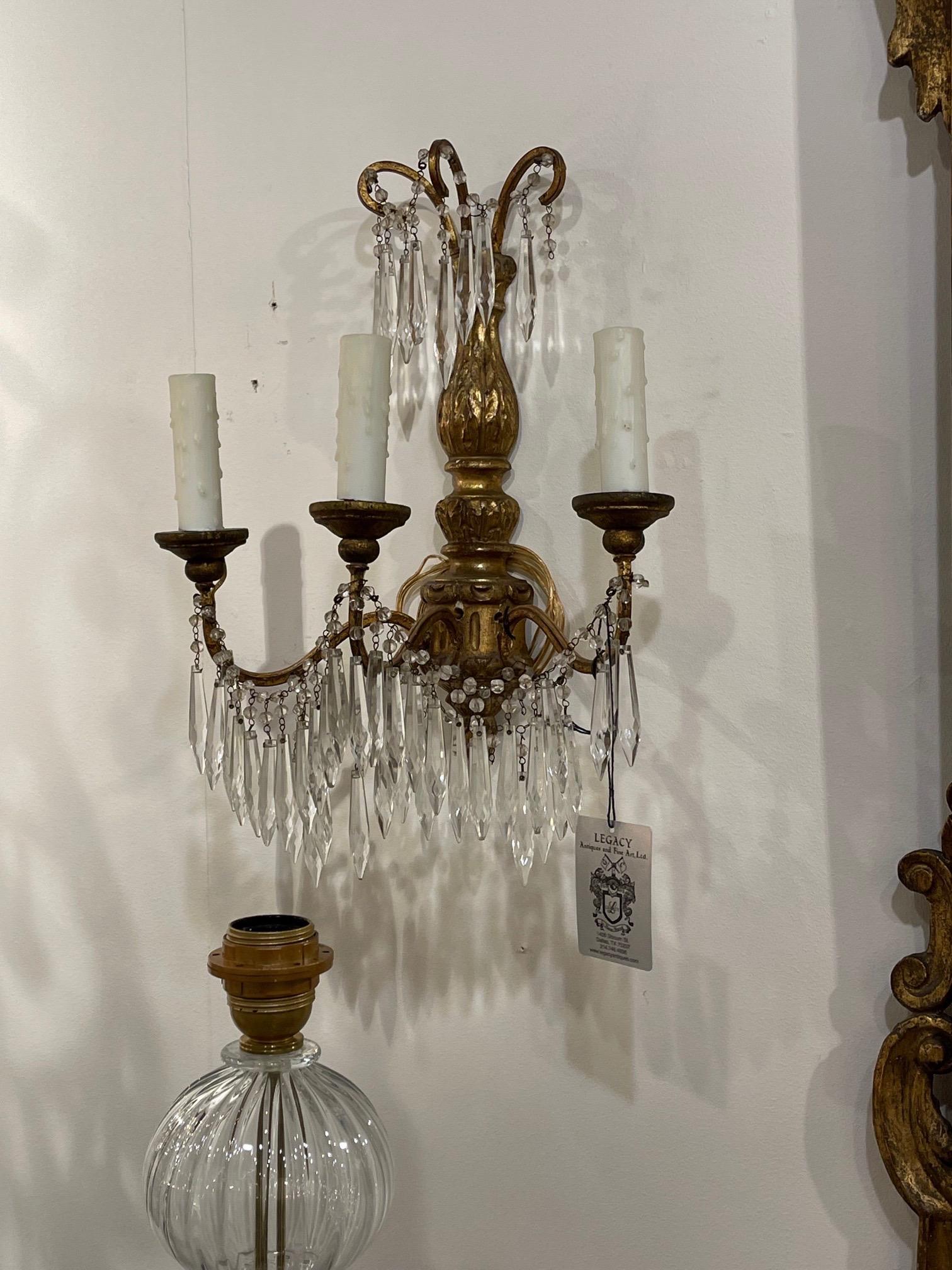 Carved Pair of Antique Italian Giltwood and Crystal 3 Light Wall Sconces