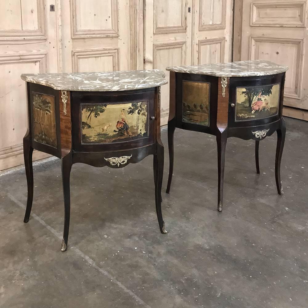 Pair of antique Italian marble-top painted cabinets or nightstands feature serpentine sides and bowed fronts, each panel of which has been adorned with an original hand-painted artwork that makes the pair truly unique! Romantic scenes appear on the