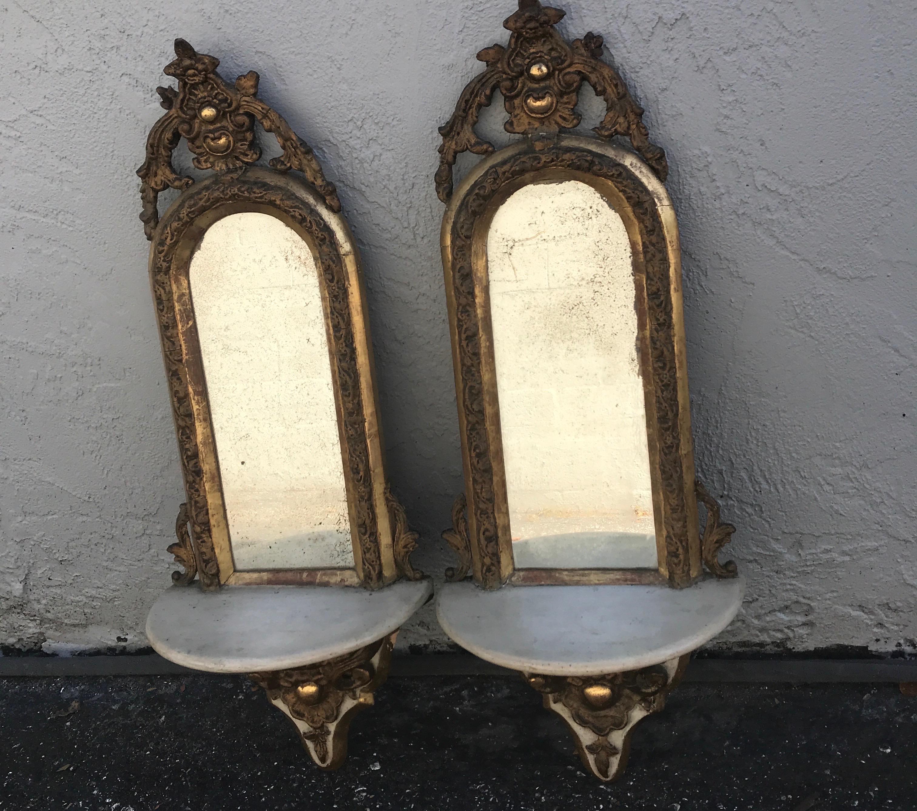 Pair of Antique wall brackets with water gilding & mirrored back.