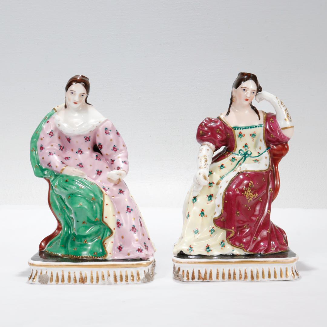 A fine pair of French porcelain figural perfume bottles. 

Each in the form of a lady - one is garbed in a pink dress with green shawl and the other in yellow dress with red shawl.

Both rest atop a rectangular plinth with gilt accents.

Simply a