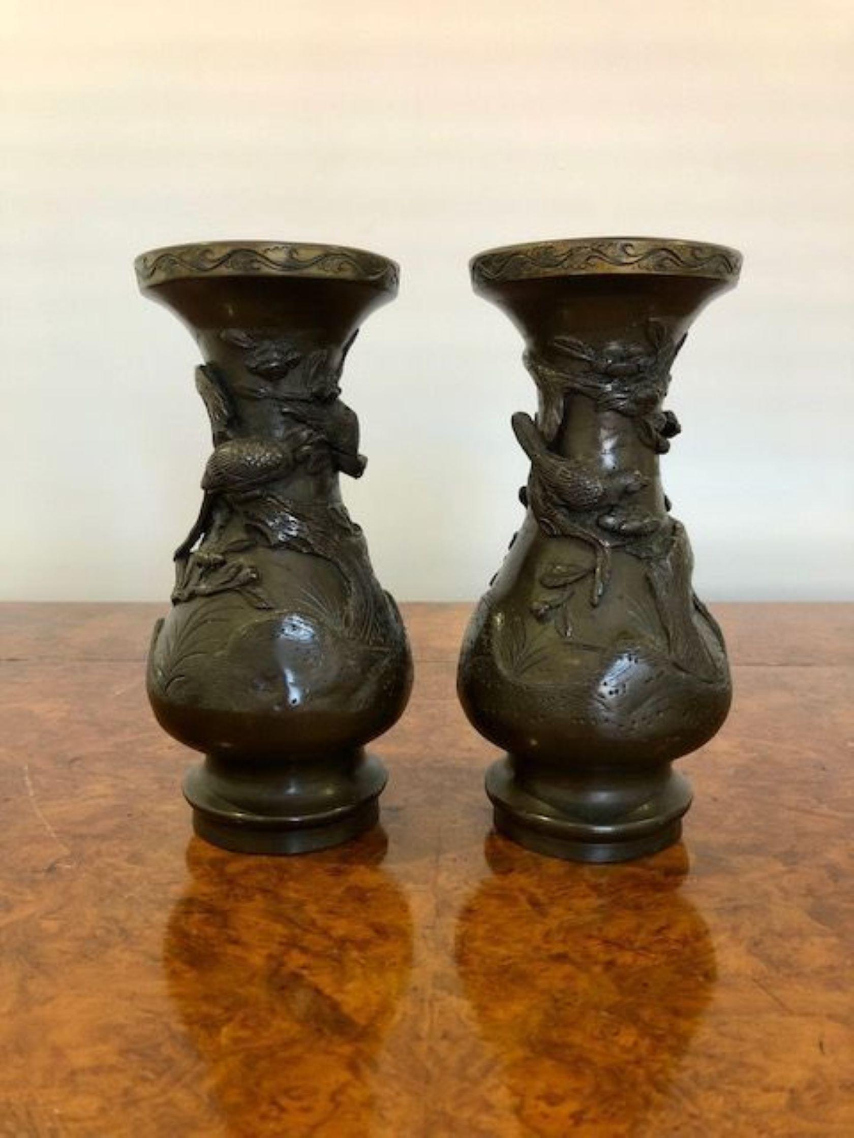 Pair of antique Japanese bronze vases Meiji period. Having raised trees, birds and flowers, nice decorated tops