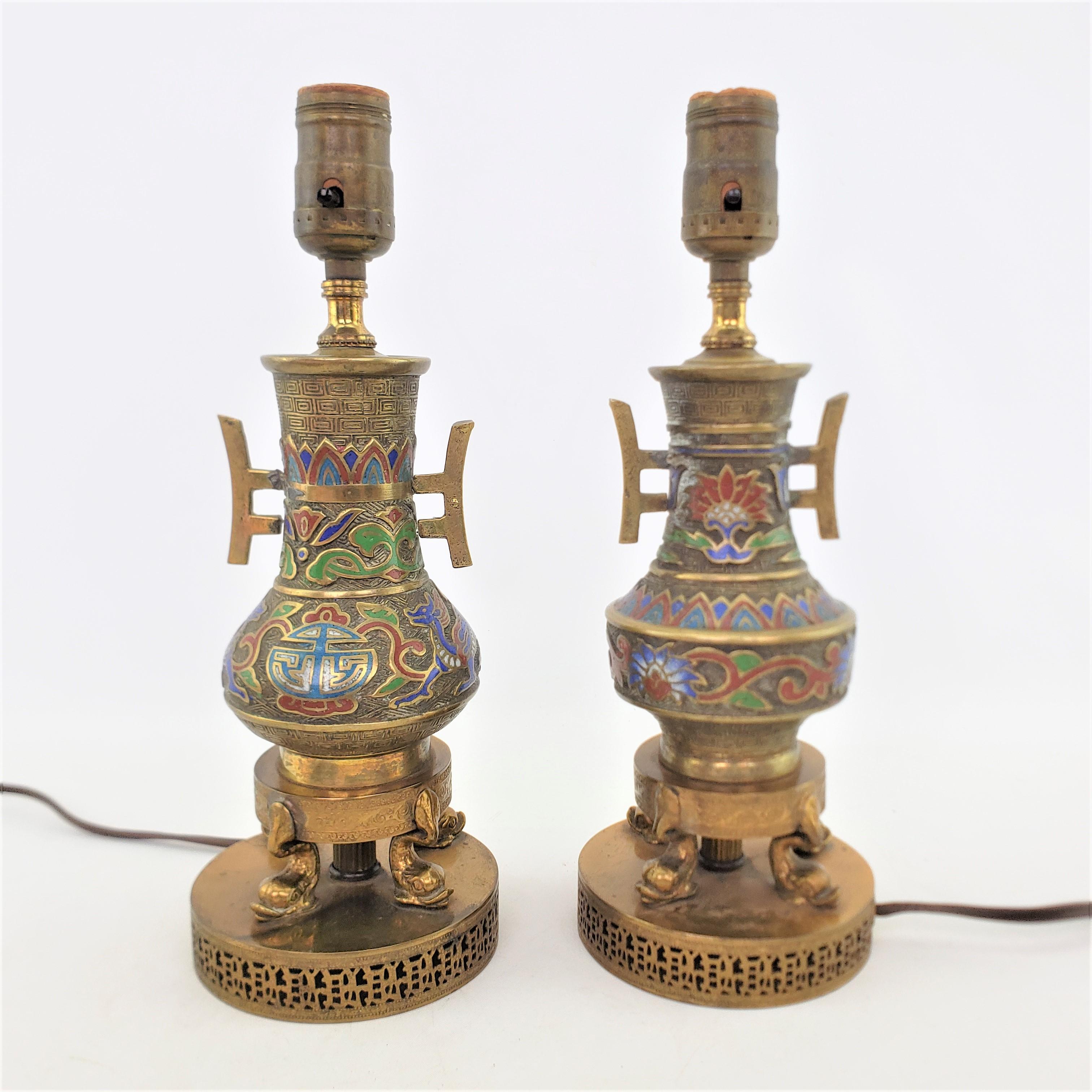 This pair of unmatched antique lamps are unsigned, but presumed to have originated from Japan and date to approximately 1920 and done in an Anglo-Japanese style. These small accent or 'boudoir' lamps may have once been vases, and are composed of