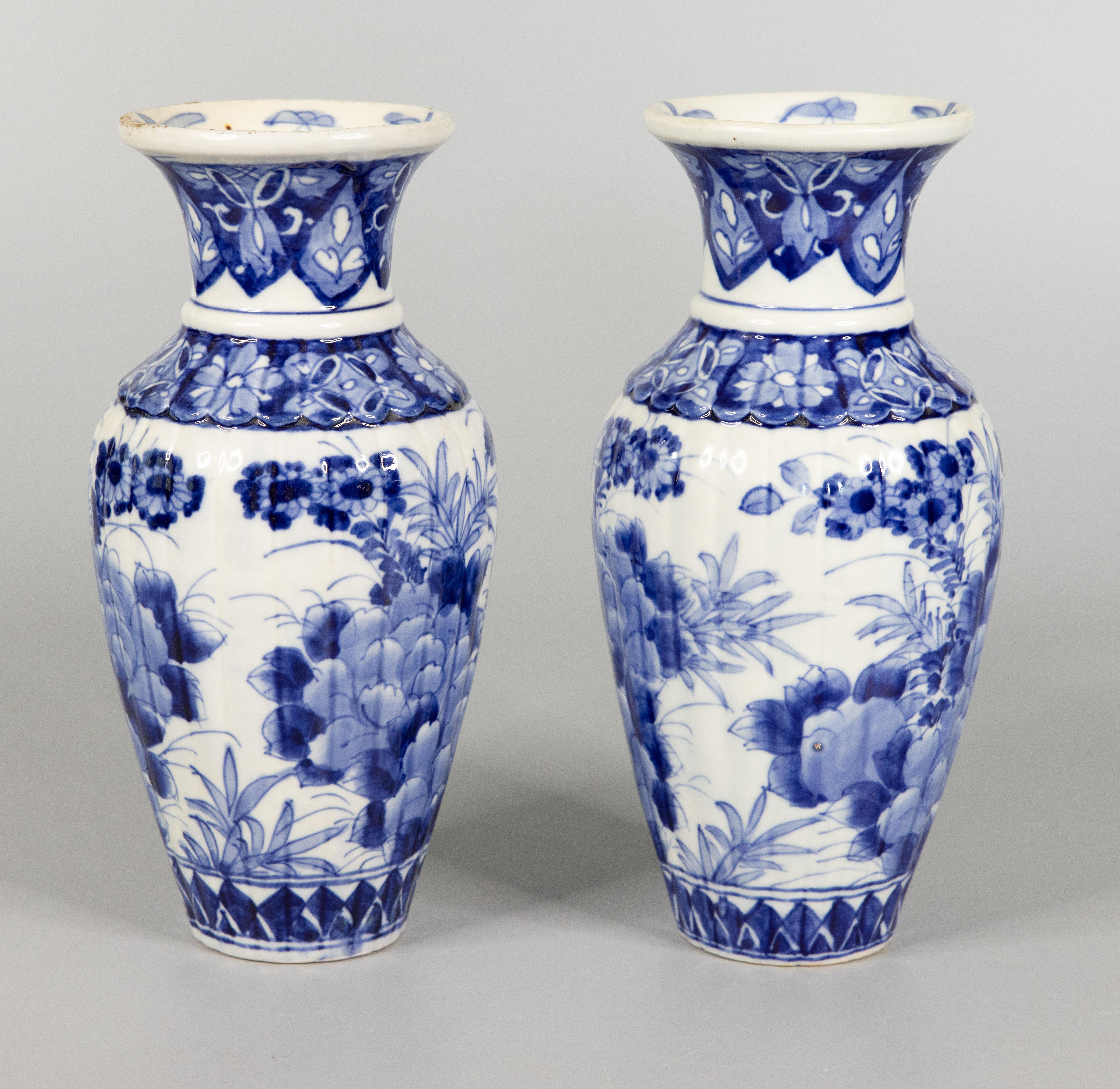 A gorgeous pair of antique Japanese Imari vases made during the Meiji period, circa 1900. These fine vases have a lovely baluster form with a ribbed design and a hand painted blue and white floral motif. They are in excellent condition and would be