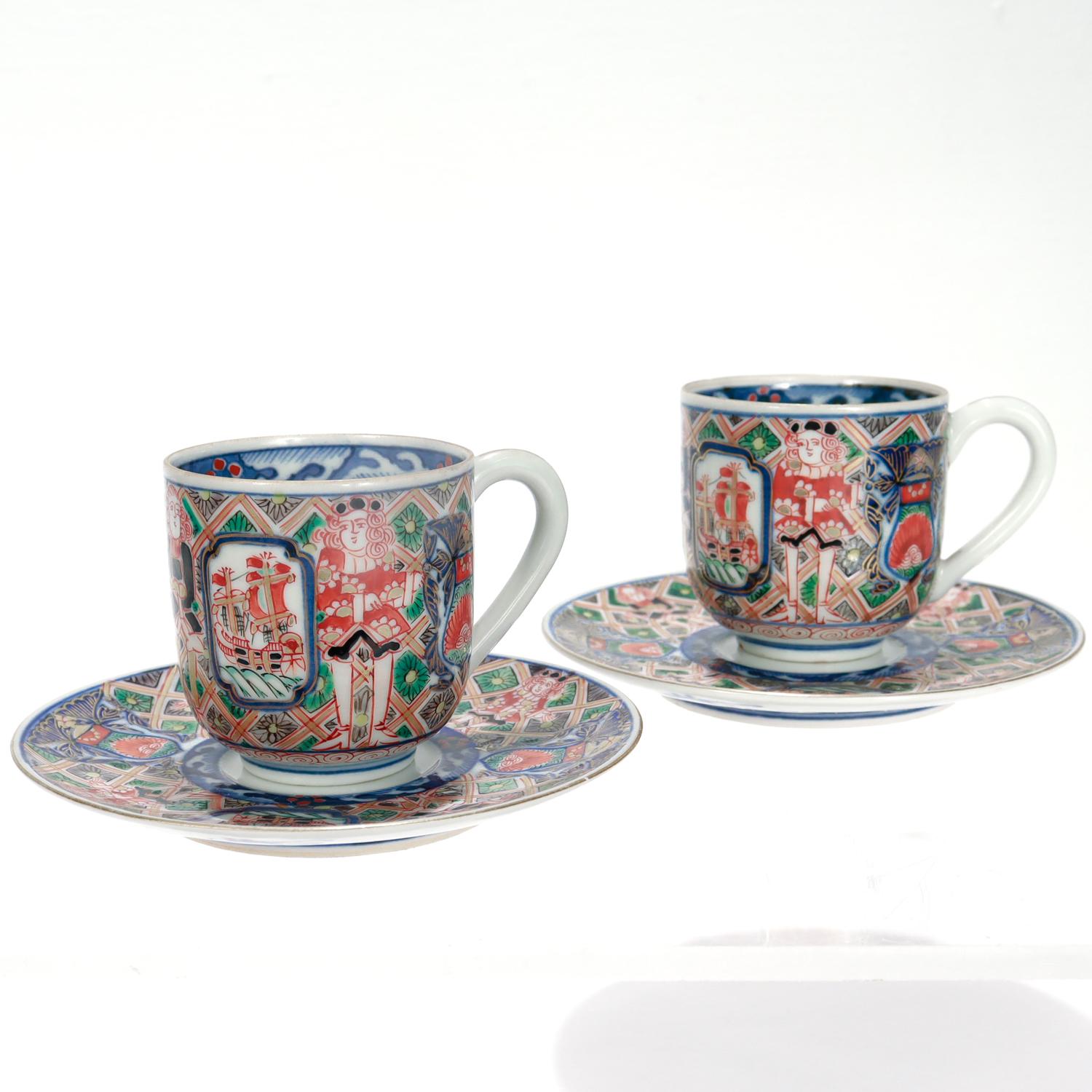 A fine pair of antique Japanese Imari porcelains demitasse coffee or tea cups & saucers.

In the 'Black Ship' pattern.

Decorated throughout with painted depictions of Western sailors and their ships in reds, blues, and greens with extensive gilt