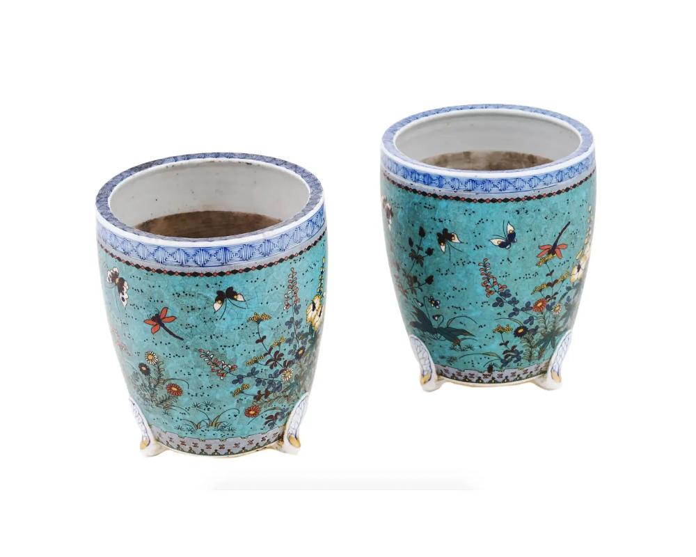 A pair of antique Japanese Meiji period cloisonne enamel cash pots manufactured in the Totai technique. Each is crafted with a combination of enamel and wirework forming intricate butterfly and floral designs on its surface. These pots are signed,
