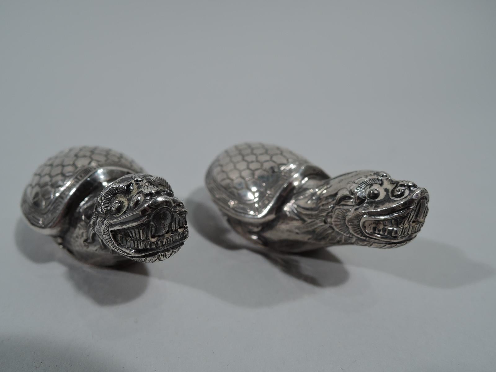 Pair of Japanese silver figural salt and pepper shakers, ca 1920. Each: An exotic fantasy turtle with scaly shell, stretched out neck, and snapping mouth. Bared teeth pierced. Bottom detachable. Marked. Total weight: 1 troy ounce.