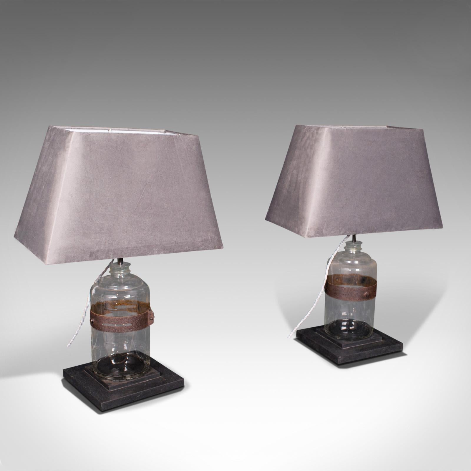 This is a pair of antique jar lamps. An English, paraffin glass jar with slate base side light, dating to the Victorian period and later, circa 1900.

Lovingly converted Victorian paraffin jars with an inviting, warm glow
Displaying a desirable