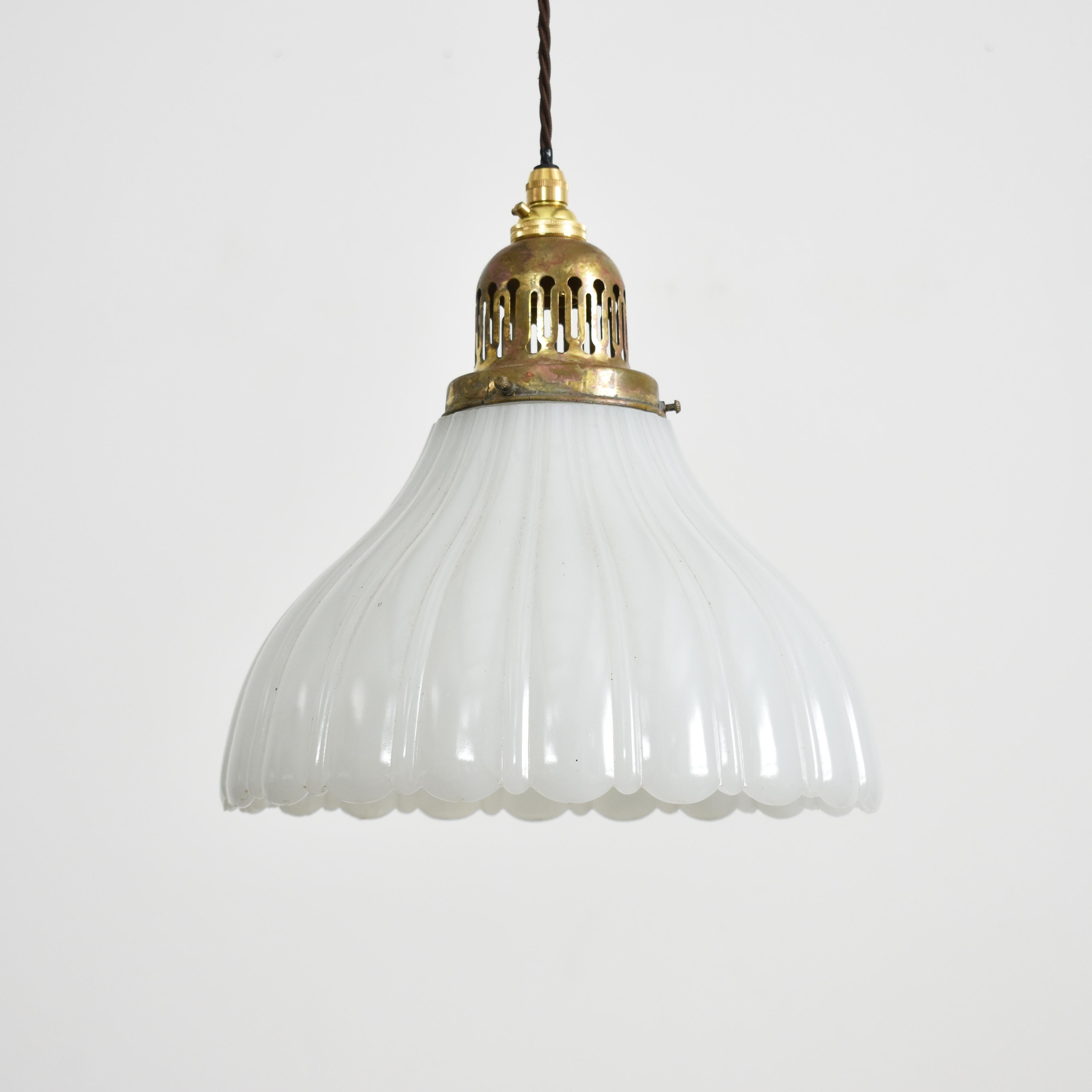 Pair of Antique Jefferson Moonstone Glass Pendant Lights

An early pair of milk glass Jefferson moonstone pendant lights. The lights retain their original brass vented galleries. The lights have their makers mark stamped onto the