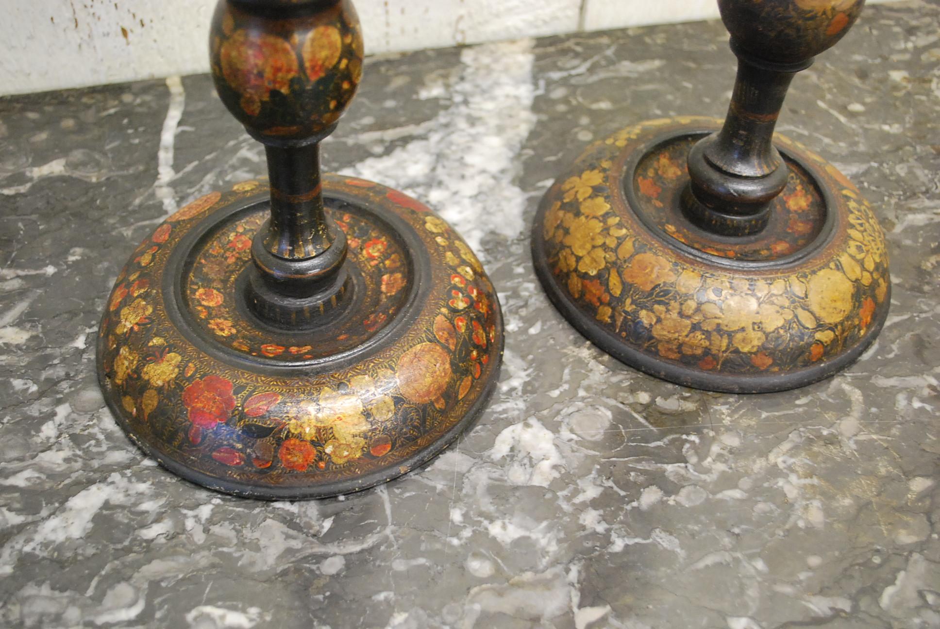A very good near pair of antique Kashmiri candlesticks of good large proportions with open twisted centres. Turned in wood and then embellished in hand painted decoration. Highly sought after in the decorative market and difficult to find in large