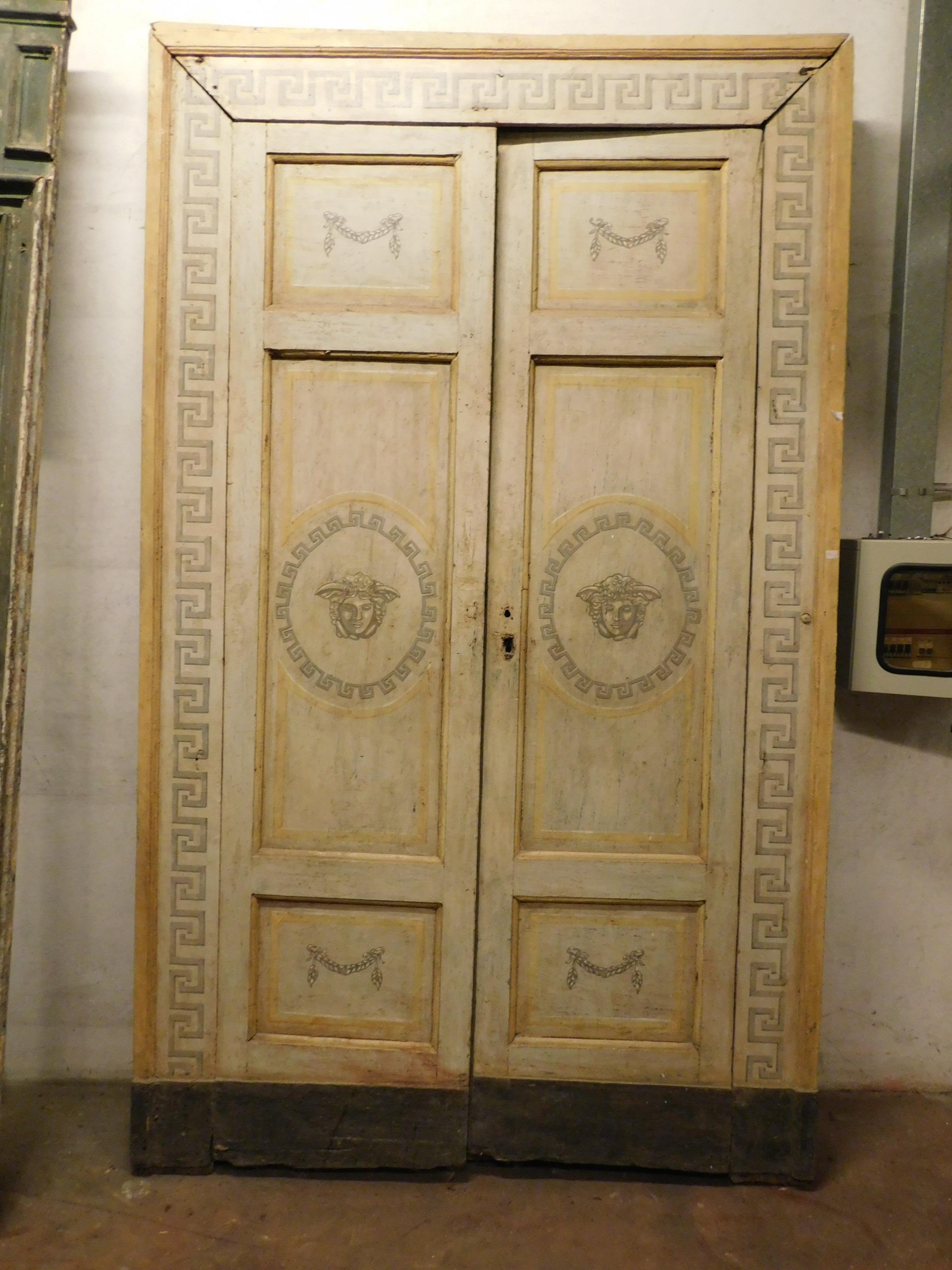 Pair of antique lacquered double doors, yellow, white and gray colors, hand painted with Greek, festoons and face of medusa, designed in full Louis XVI style, from southern Italy, beautiful in pairs, they are impressive in size and delightful for