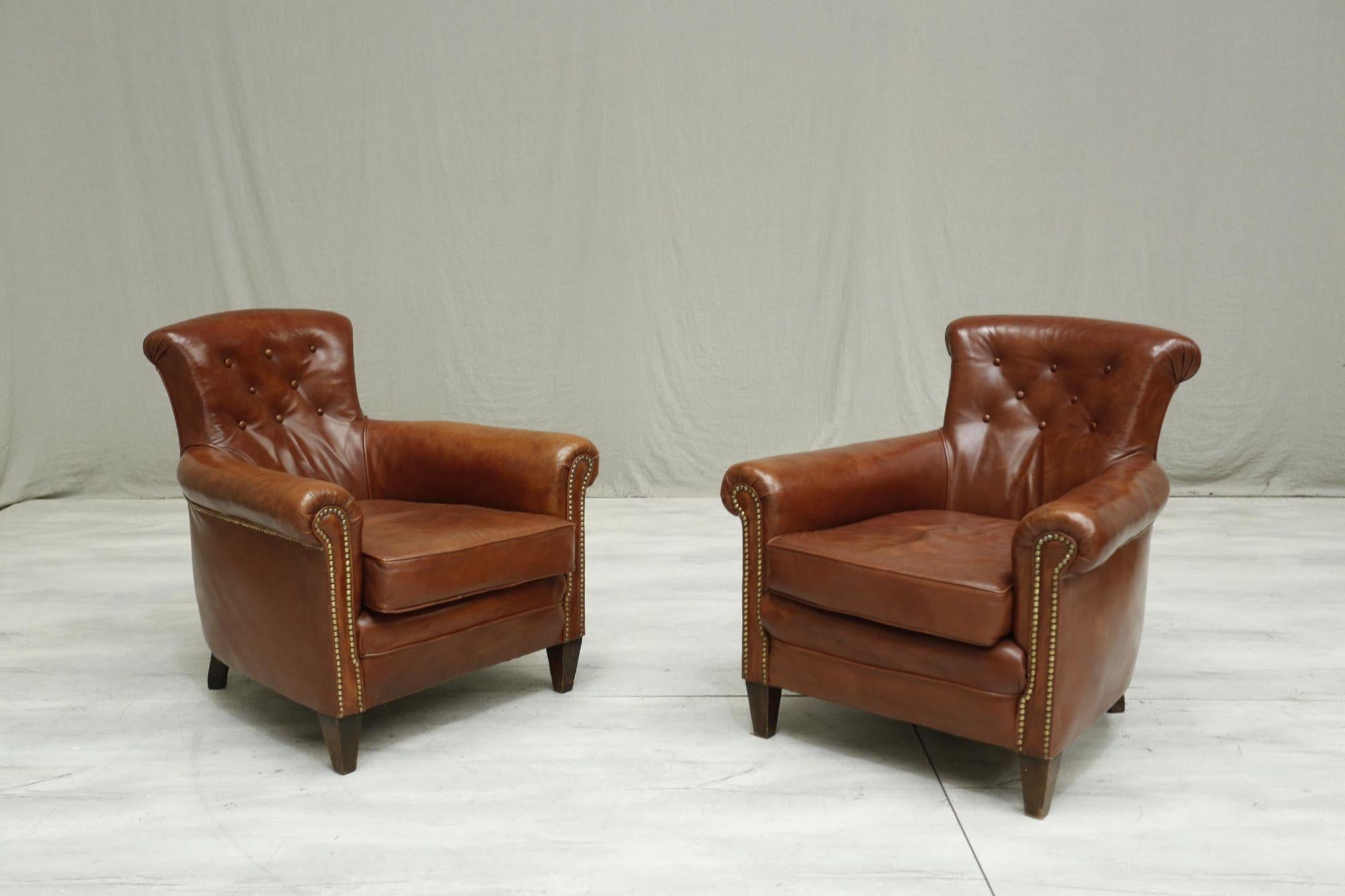 These are a stunning pair of early 20th century leather armchairs. Great original patinated leather waxed and treated so that it is in stunning condition. The depth of seat of these makes very comfy and ideal for everyday use. The design is very