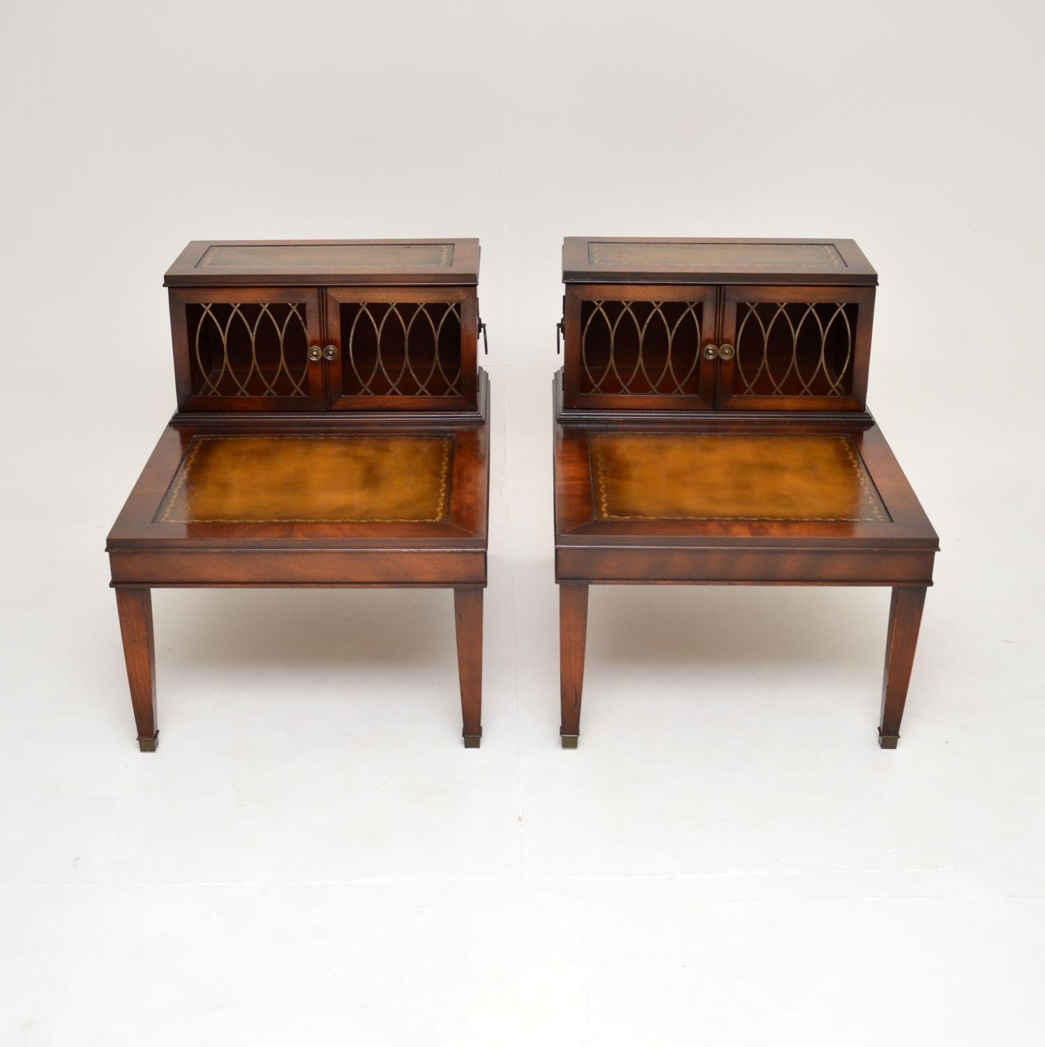A large and very impressive pair of antique leather top side tables in the Georgian style, dating from around the 1930-50’s.

The quality is excellent, they are a great size and have useful cabinet sections at the backs with pierced brass door