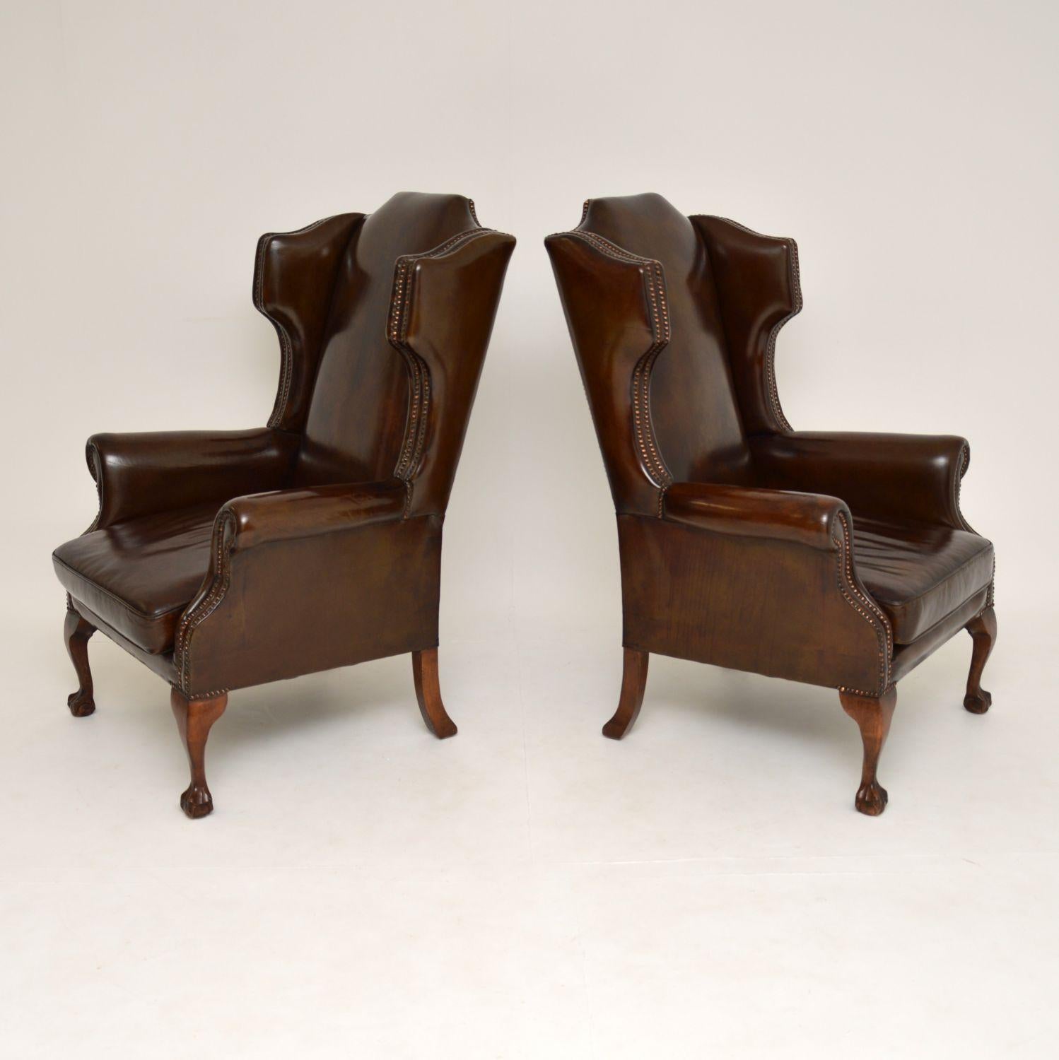 A stunning pair of top quality leather wing back armchairs, in the antique Georgian style, dating from circa 1930s period.

They have a gorgeous and unusual shape and are also extremely comfortable, with generous proportions. They have double