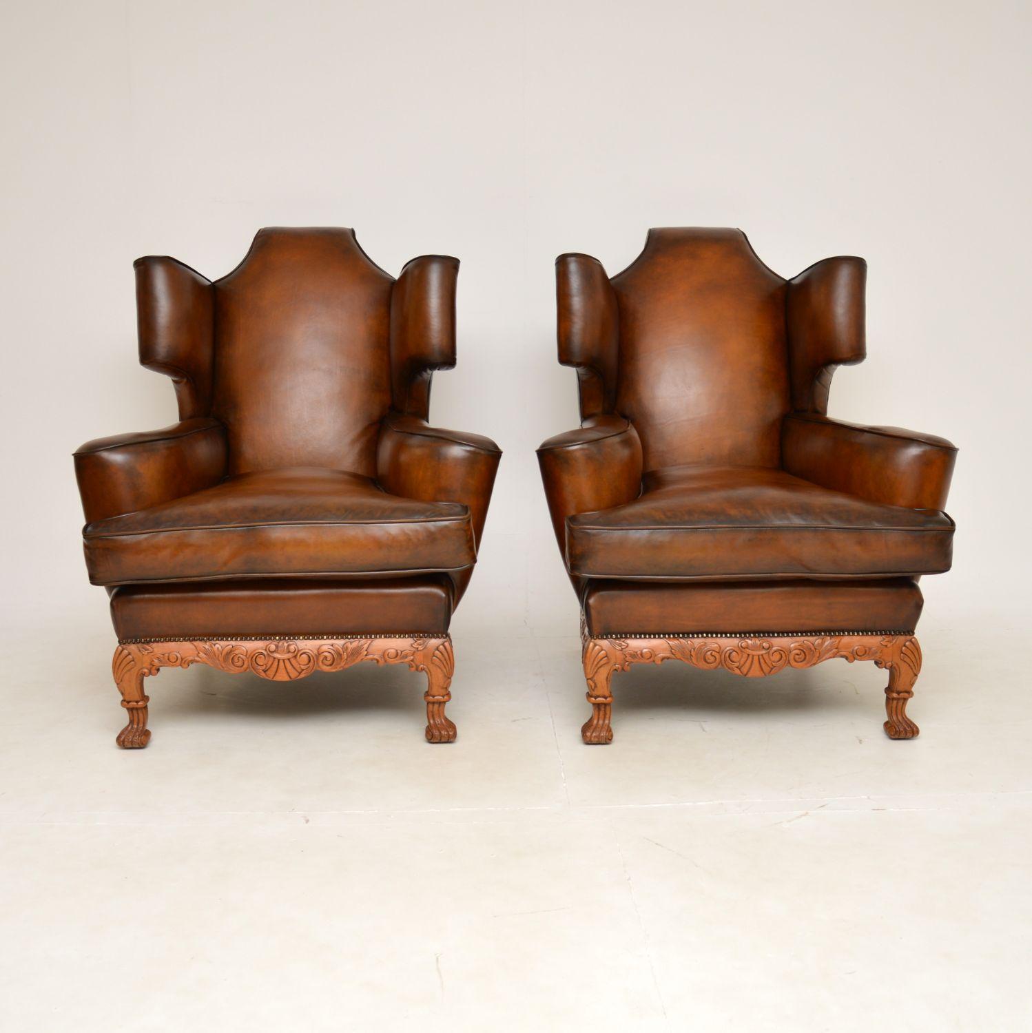 A magnificent pair of antique leather wing back armchairs, possibly the finest pair we have come across. They were made in England, and they date from around the 1920’s.

They are of very impressive large proportions, the quality is absolutely