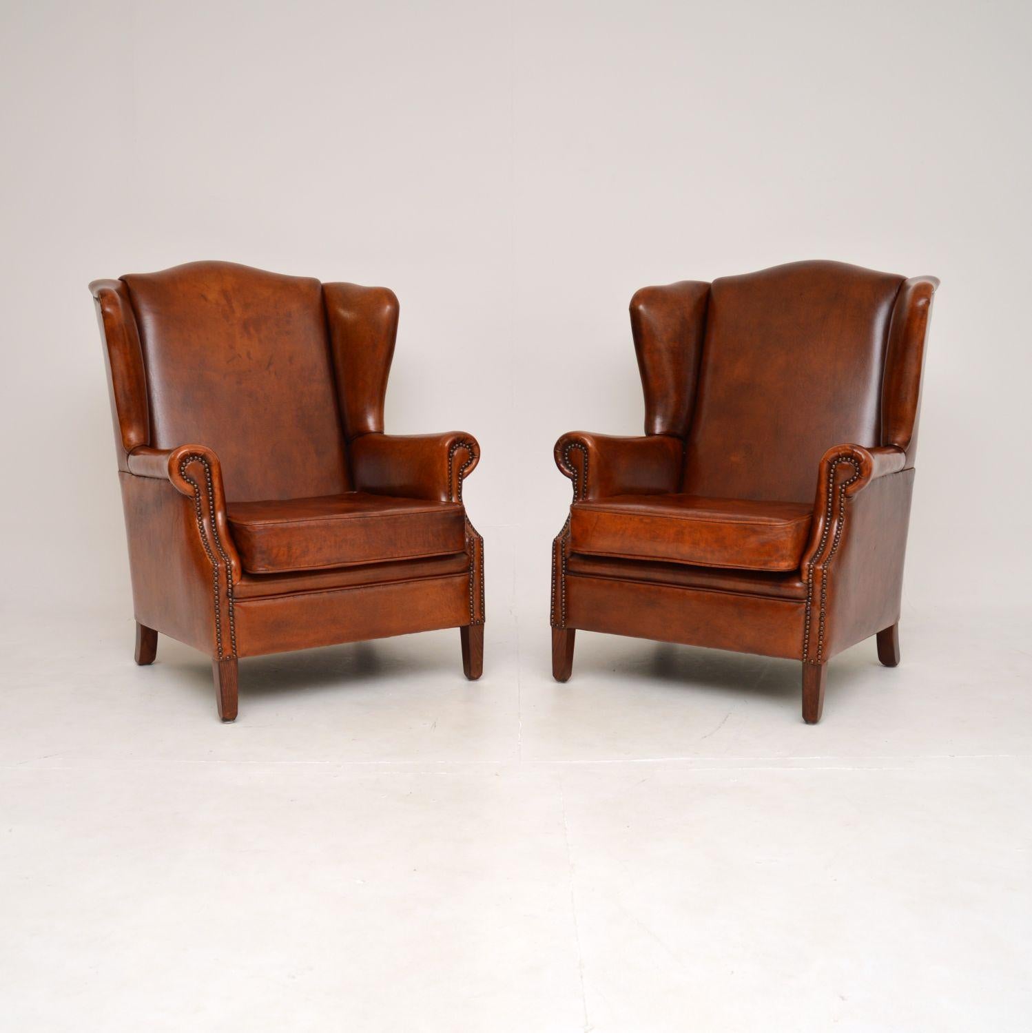 A beautiful and extremely comfortable pair of antique leather wing back armchairs. They were made in France, they date from around the 1950’s.

The quality is superb, they are very generous in proportion and supportive. The brown leather has a