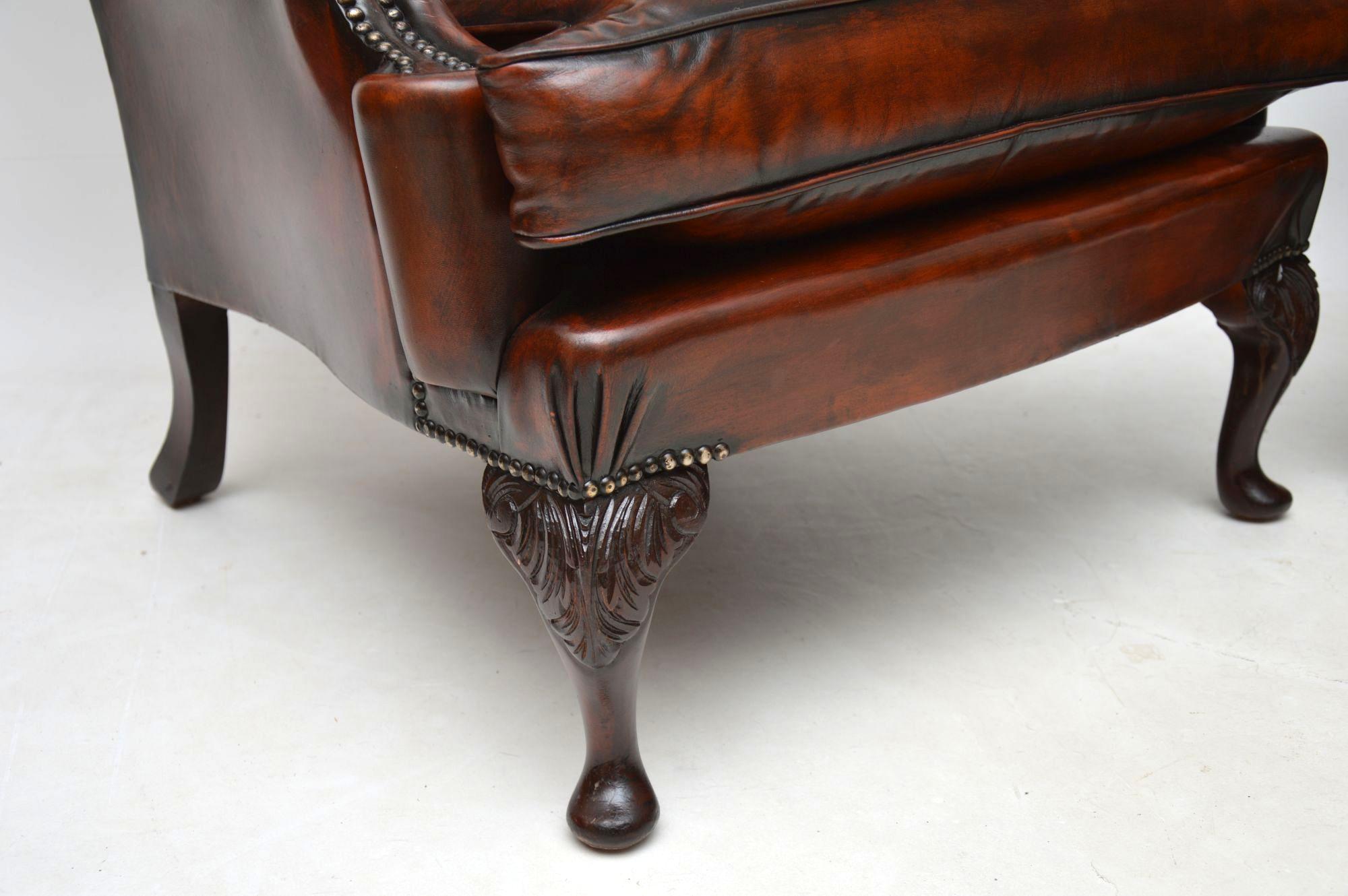 Large comfortable pair of antique leather wing armchairs with deep buttoned backs and loose cushion seats. They are a lovely naturally distressed color and show plenty of character with plenty of shading. The inside of the arms have leather covered