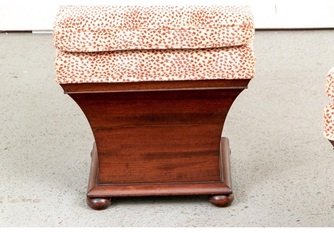 Stylized curved hourglass form stools with hinged tops opening for storage. Raised on bun feet. Newly upholstered in a striped cut velveteen animal print in rust and cream with a cushion top.
Measures: Height 21