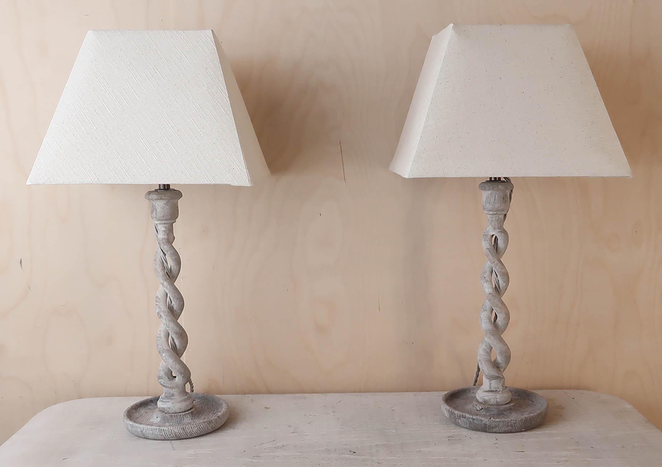 Super pair of limed oak open twist table lamps.

English. Early 20th century.

Converted from candlesticks.

 Wired to UK standards.

Shades included.